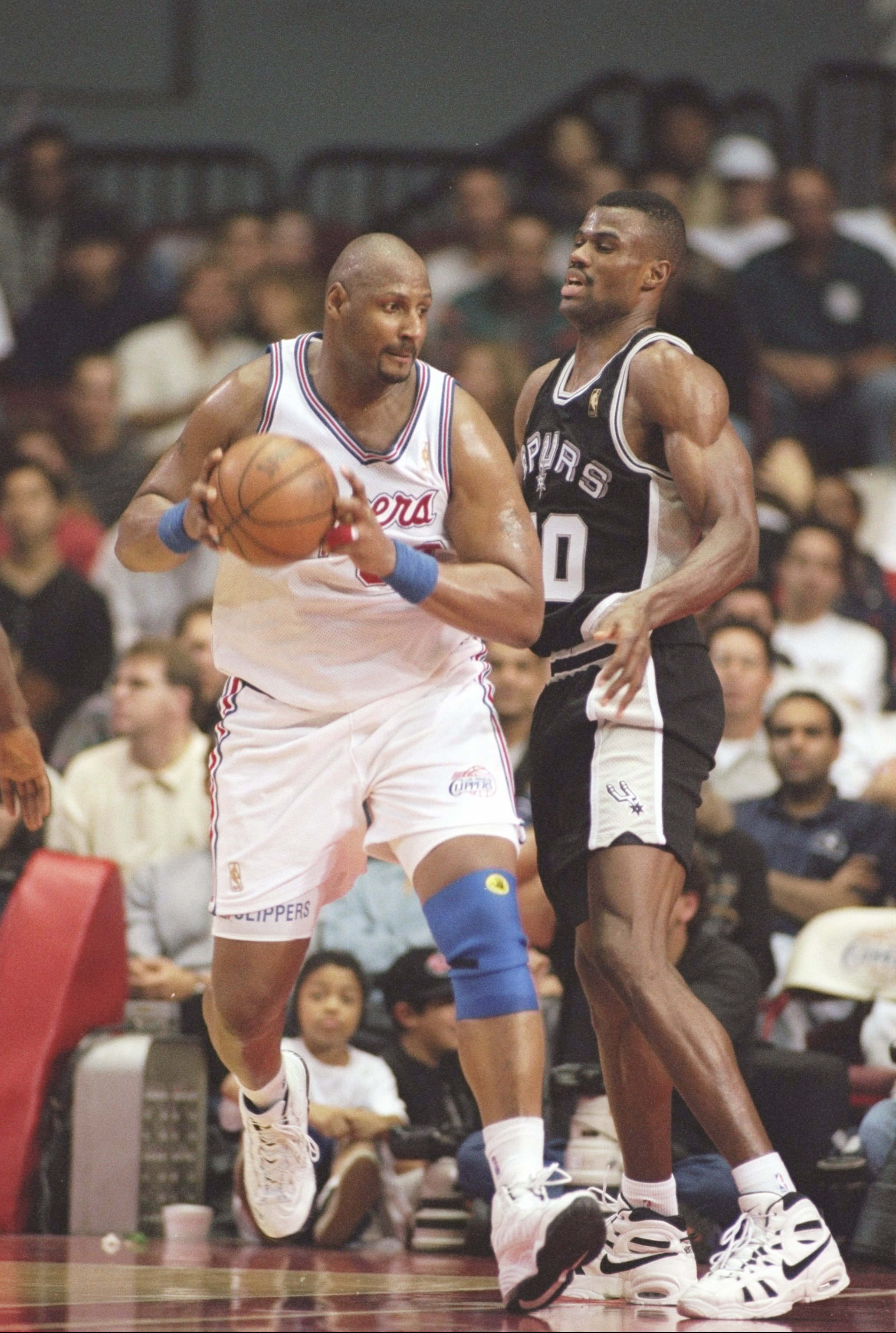 12 Dec 1996:  Center Kevin Duckworth of the Los Angeles Clippers tries to fend off center David Robinson of the San Antonio Spurs at the Los Angeles Sports Arena in Los Angeles, California.  The Clippers won the game 97-94. Mandatory Credit: Brian Bahr  /