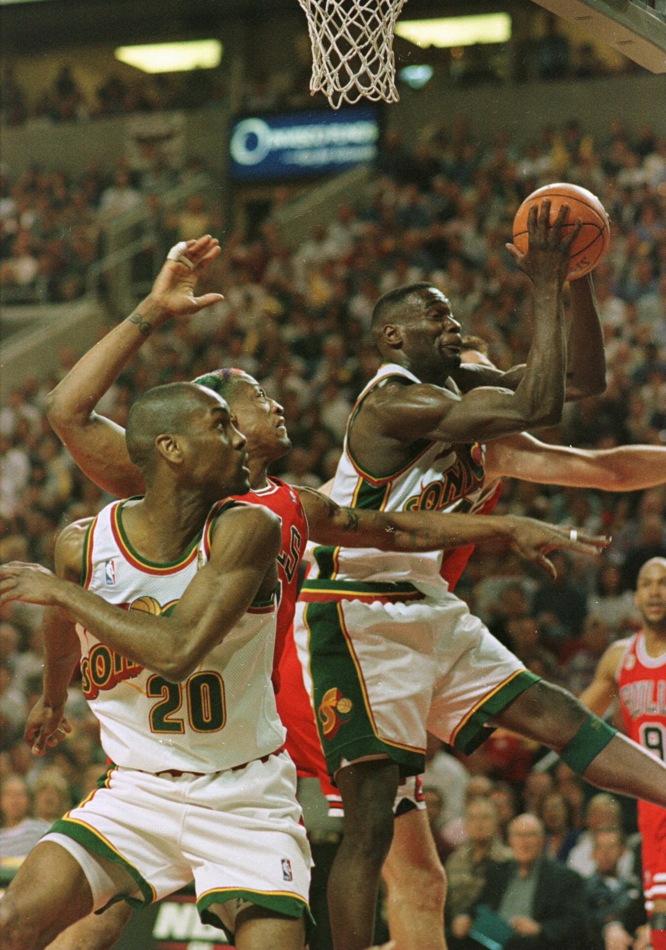 12 Jun 1996:  Shawn Kemp of the Seattle Supersonics pulls in an offensive rebound over Dennis Rodman #91 and Luc Longley (back) of the Chicago Bulls as Supersonics teammate Gary Payton #20 looks on during the first half of the fourth game of the NBA Final