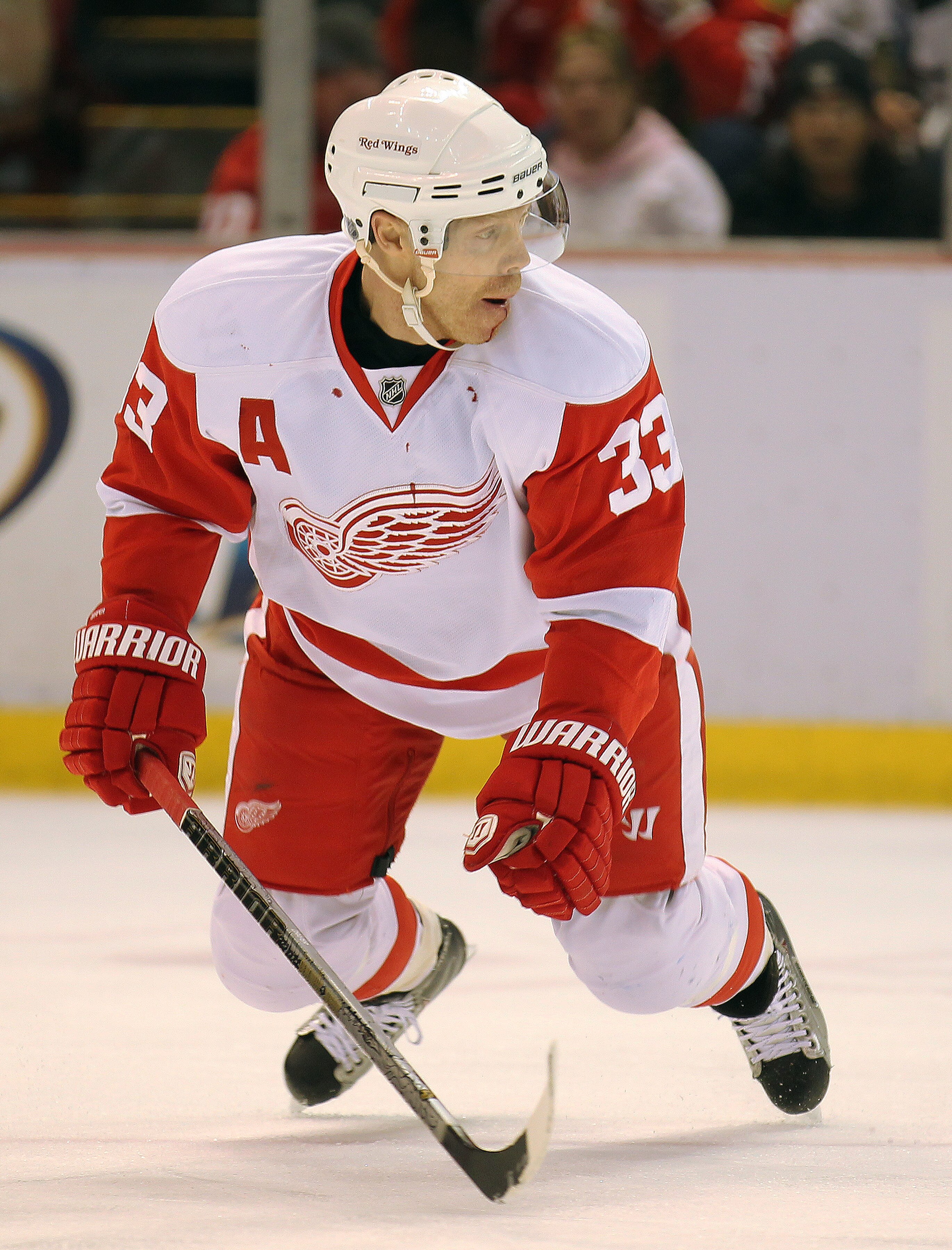 DETROIT, MI - JANUARY 22:  Kris Draper #33 of the Detroit Red Wings gets set to block a shot in a game against the Chicago Black Hawks on January 22, 2011 at the Joe Louis Arena in Detroit, Michigan. The Hawks defeated the Wings 4-1. (Photo by Claus Ander
