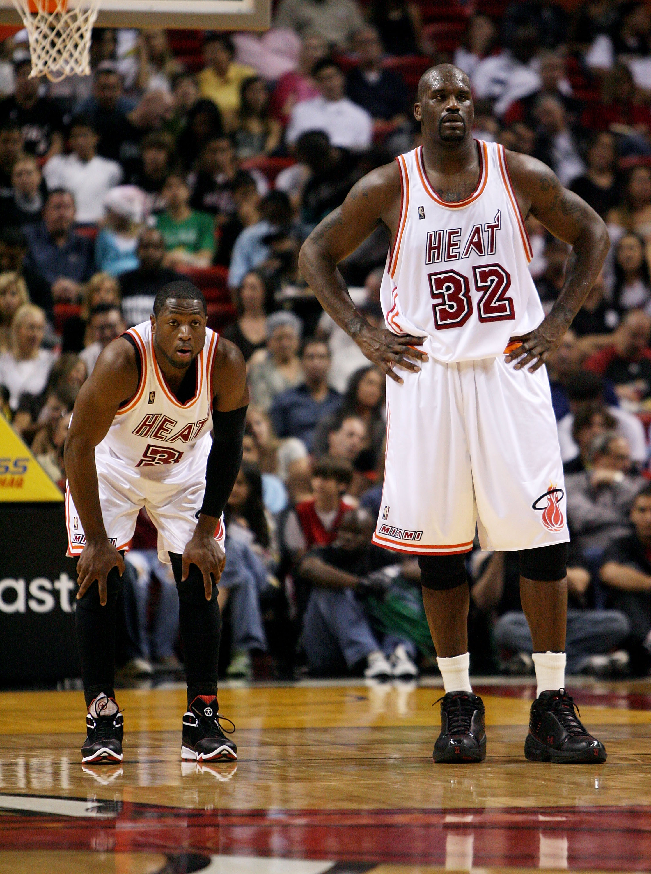 MIAMI - DECEMBER 22:  Dwyane Wade #3 and Shaquille O'Neal #32 of the Miami Heat watch as the Utah Jazz shoot free throws at American Airlines Arena December 22, 2007 in Miami, Florida. The Heat defeated the Jazz 104-102. NOTE TO USER: User expressly ackno