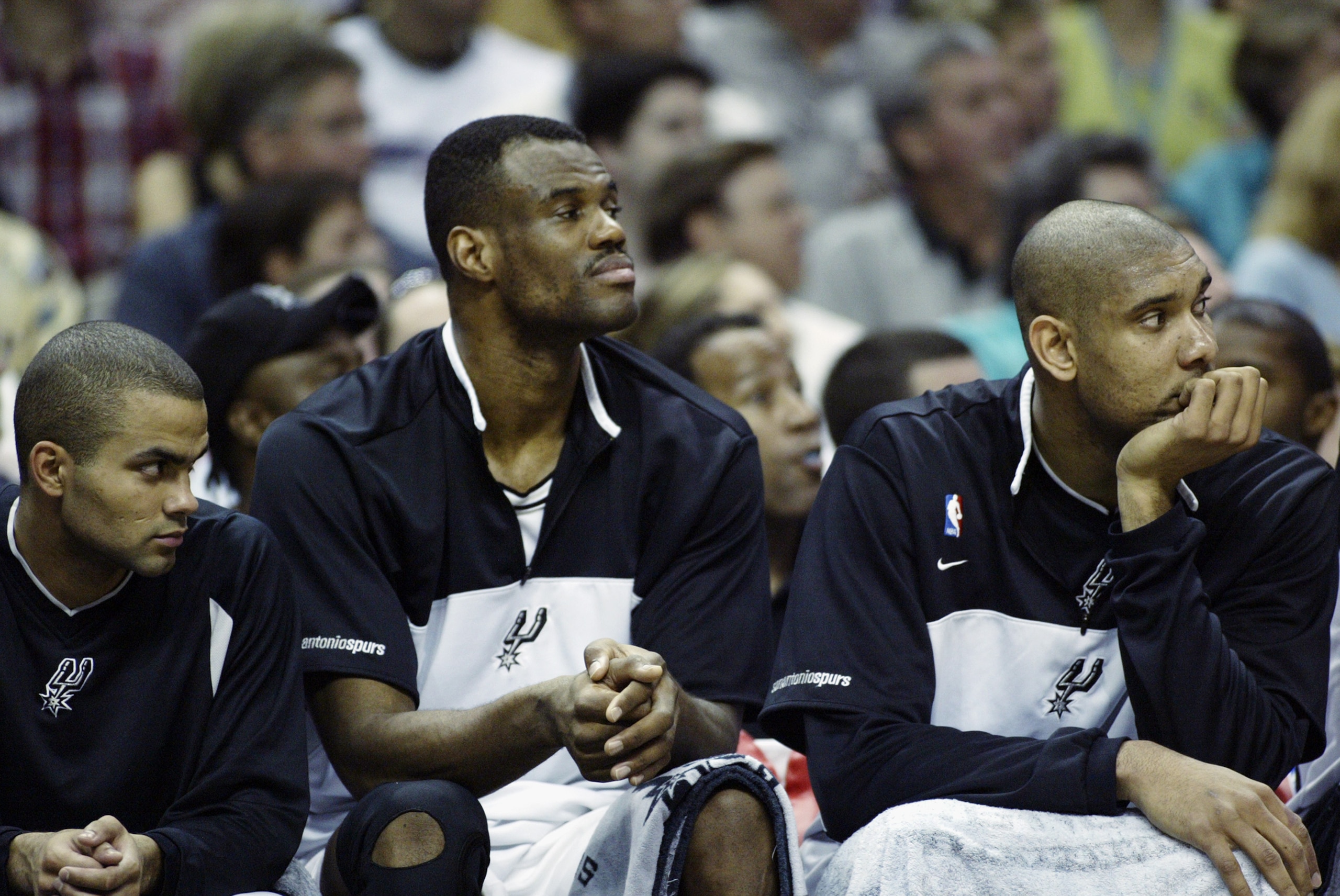SAN ANTONIO - MAY 19:  (Left to Right) Tony Parker #9, David Robinson #50, and Tim Duncan #21 of the San Antonio Spurs sits on the bench in Game one of the Western Conference Finals against the Dallas Mavericks during the 2003 NBA Playoffs at SBC Center o