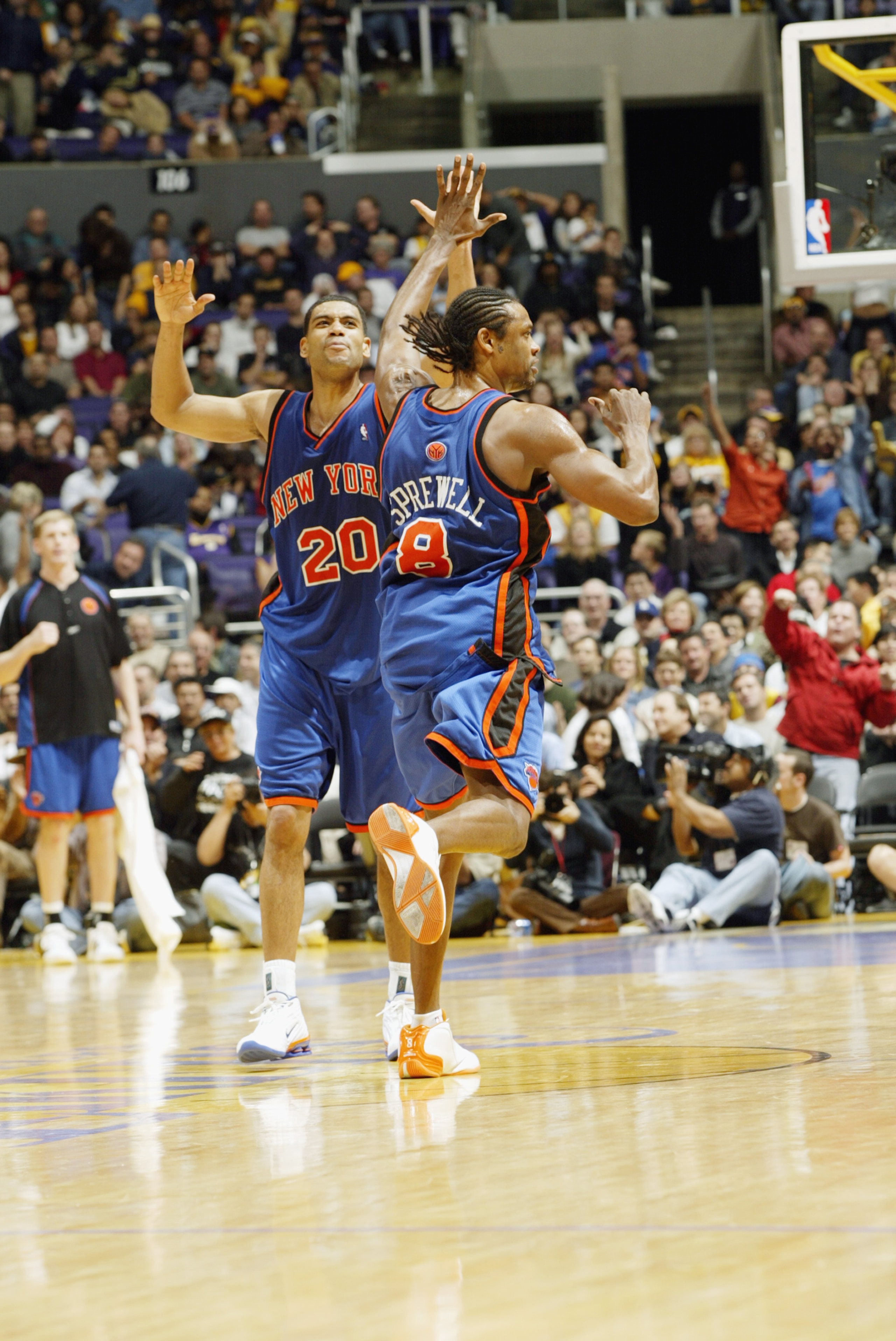 LOS ANGELES - FEBRUARY 16:  Allan Houston #20 high fives Latrell Sprewell #9 of the New York Knicks during the NBA game against the Los Angeles Lakers at Staples Center on February 16, 2003 in Los Angeles, California.  The Knicks won 117-110.  NOTE TO USE