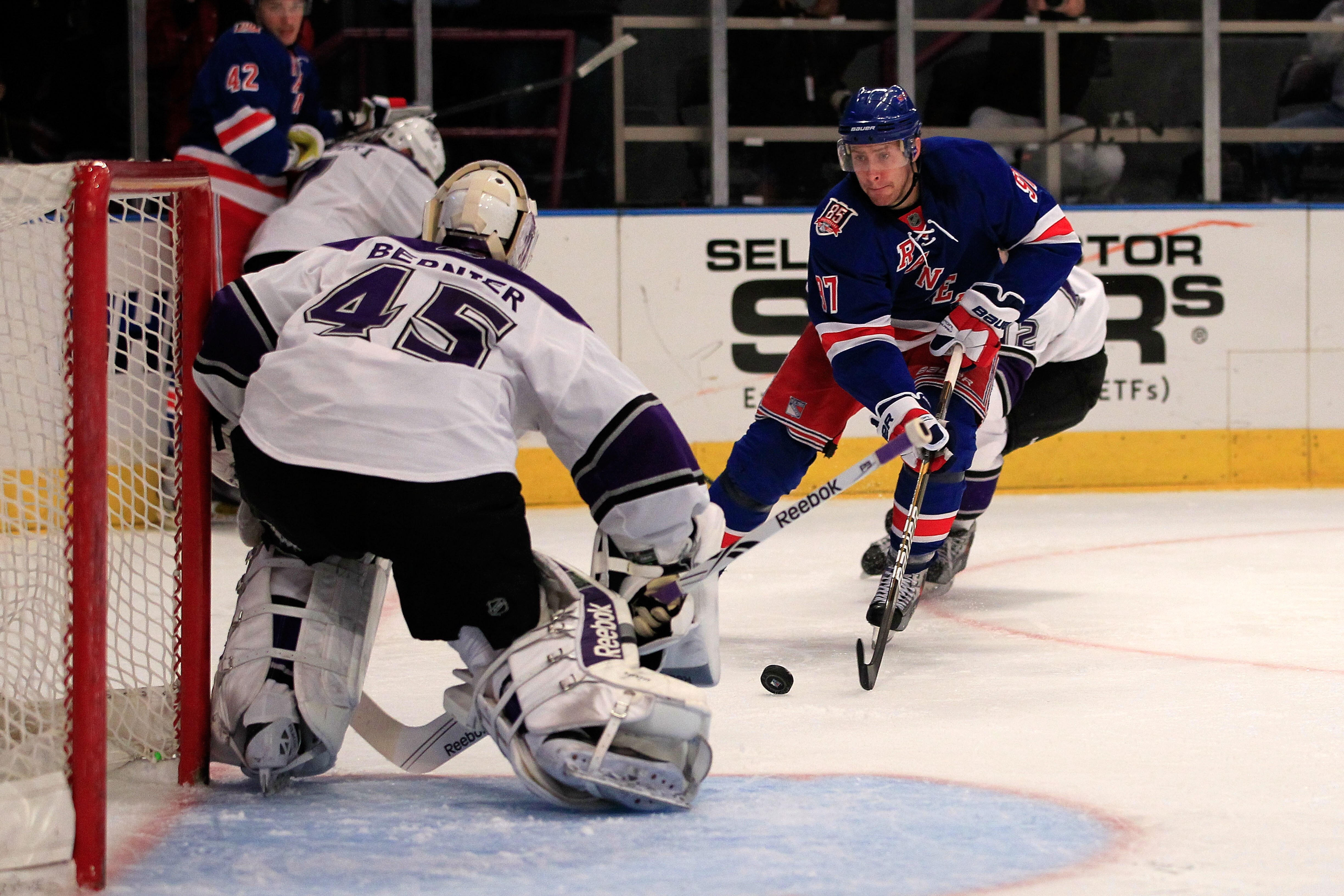NEW YORK, NY - FEBRUARY 17: Matt Gilroy #97 of the New York Rangers challenges Johnathan Bernier of the Los Angeles Kings at Madison Square Garden on February 17, 2011 in New York City. The Rangers defeated the Kings 4-3 after a shootout. (Photo by Chris