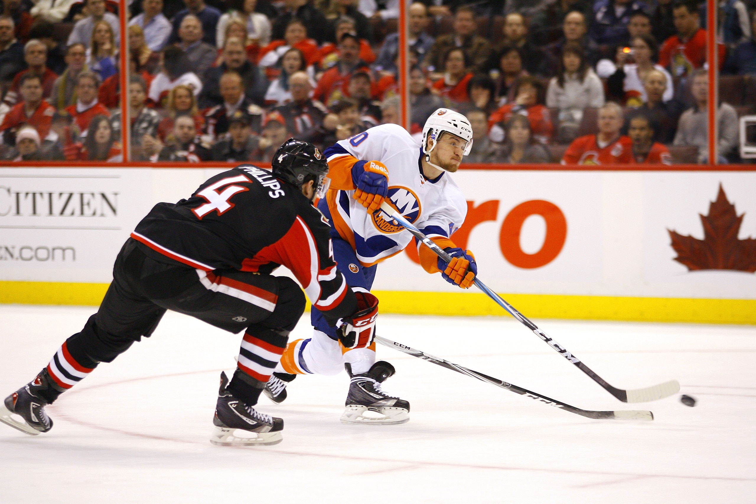OTTAWA, ON - FEBRUARY 15:  Michael Grabner #40 of the New York Islanders fires a wrist shot from the circle while Chris Phillips #4 of the Ottawa Senators tries to block the shot in a game at Scotiabank Place on February 15, 2011 in Ottawa, Ontario, Canad