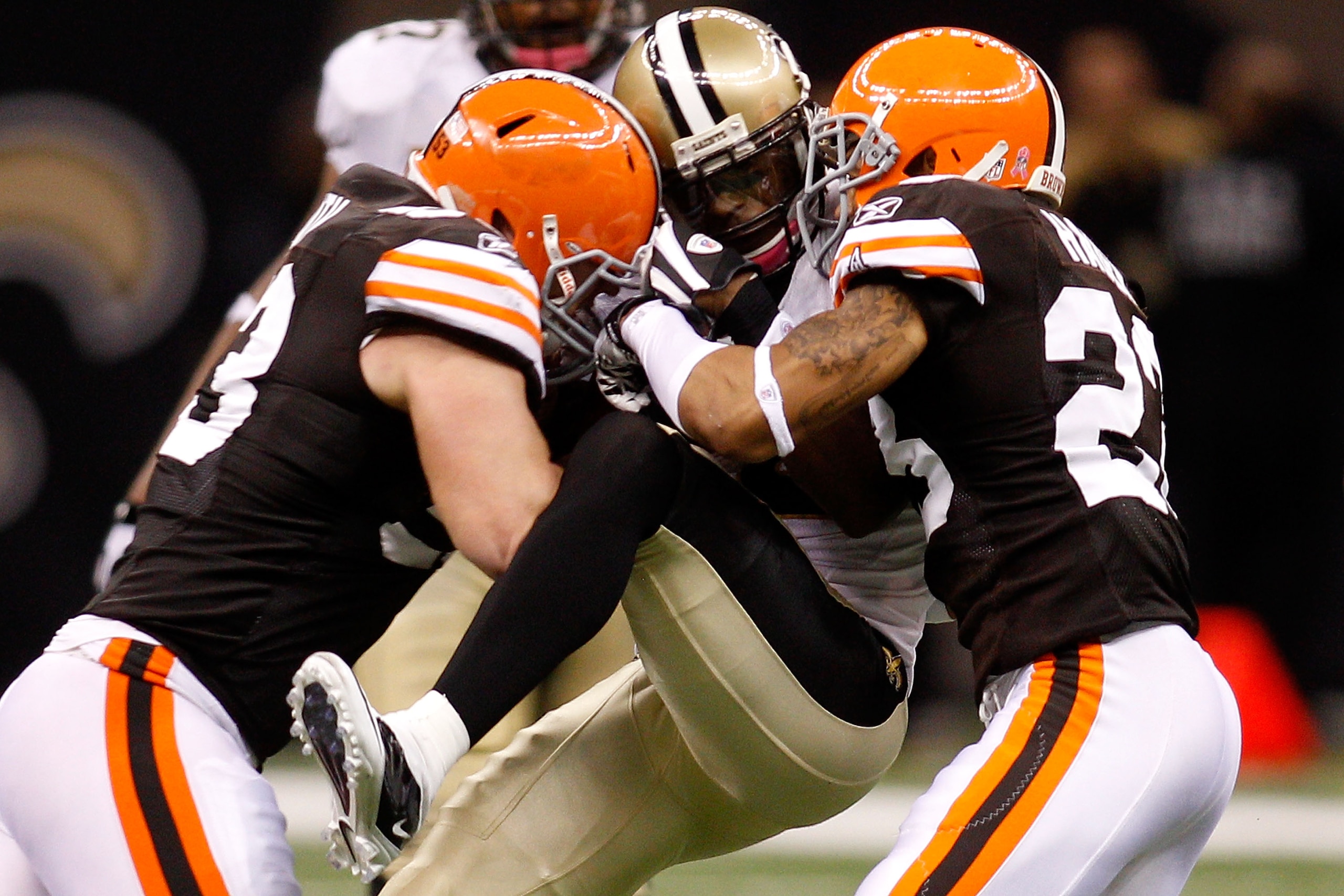NEW ORLEANS - OCTOBER 24: Marques Colston #12 of the New Orleans Saints is tackled by Joe Haden #23 and Matt Roth #53 of the Cleveland Browns at the Louisiana Superdome on October 24, 2010 in New Orleans, Louisiana. The Browns defeated the Saints 30-17. NEW ORLEANS - OCTOBER 24: Marques Colston #12 of the New Orleans Saints is tackled by Joe Haden #23 and Matt Roth #53 of the Cleveland Browns at the Louisiana Superdome on October 24, 2010 in New Orleans, Louisiana. The Browns defeated the Saints 30-17.