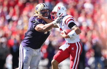 SEATTLE - SEPTEMBER 18: Quarterback Taylor Martinez #3 of the Nebraska Cornhuskers is tackled by Alameda Ta'amu #74 of the Washington Huskies on September 18, 2010 at Husky Stadium in Seattle, Washington. (Photo by Otto Greule Jr/Getty Images)