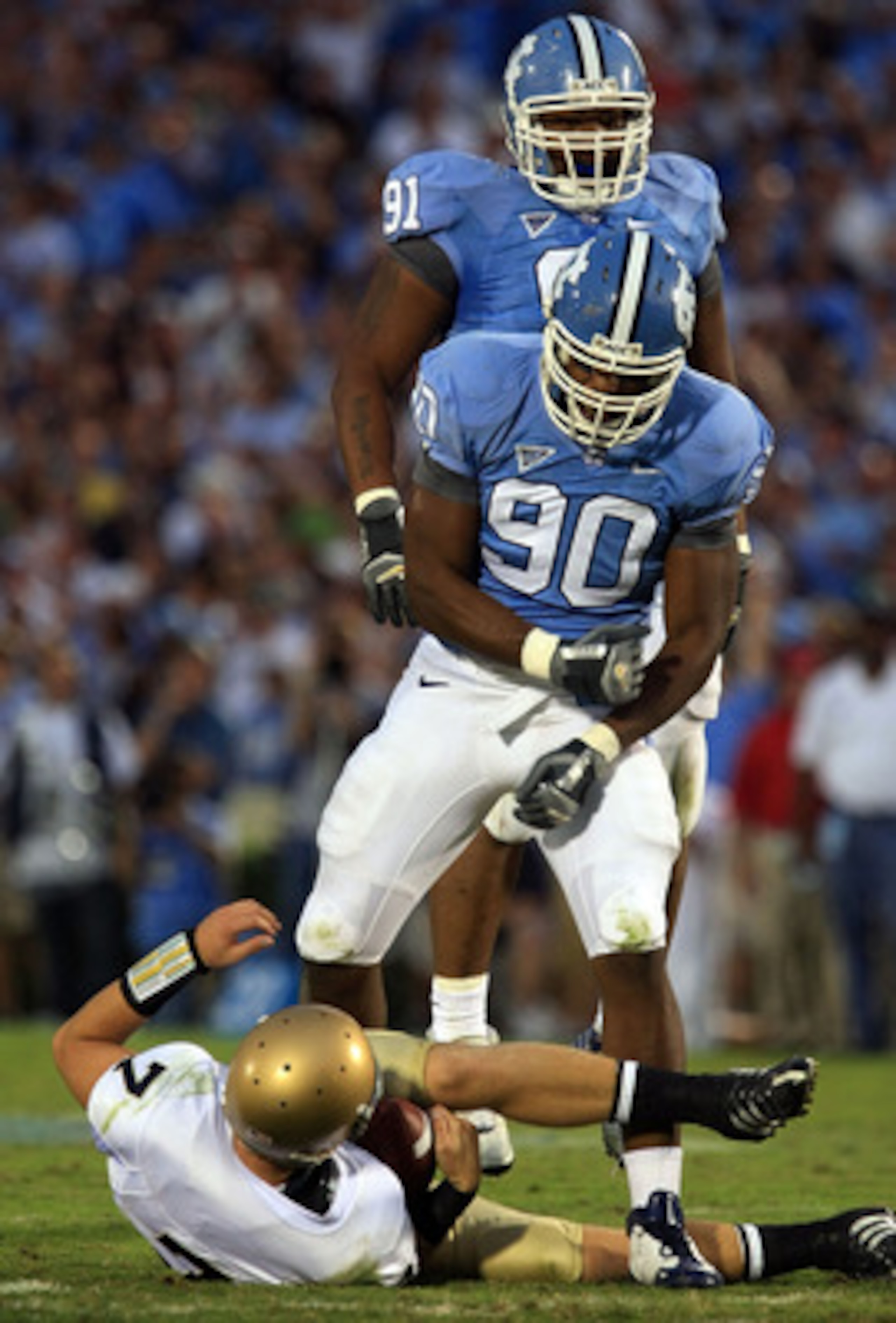 CHAPEL HILL, NC - OCTOBER 11:  Quinton Coples #90 and Tydreke Powell #91 of the North Carolina Tar Heels celebrates after sacking Jimmy Clauson #7 of the Notre Dame Fighting Irish at Kenan Stadium October 11, 2008 in Chapel Hill, North Carolina.  (Photo b