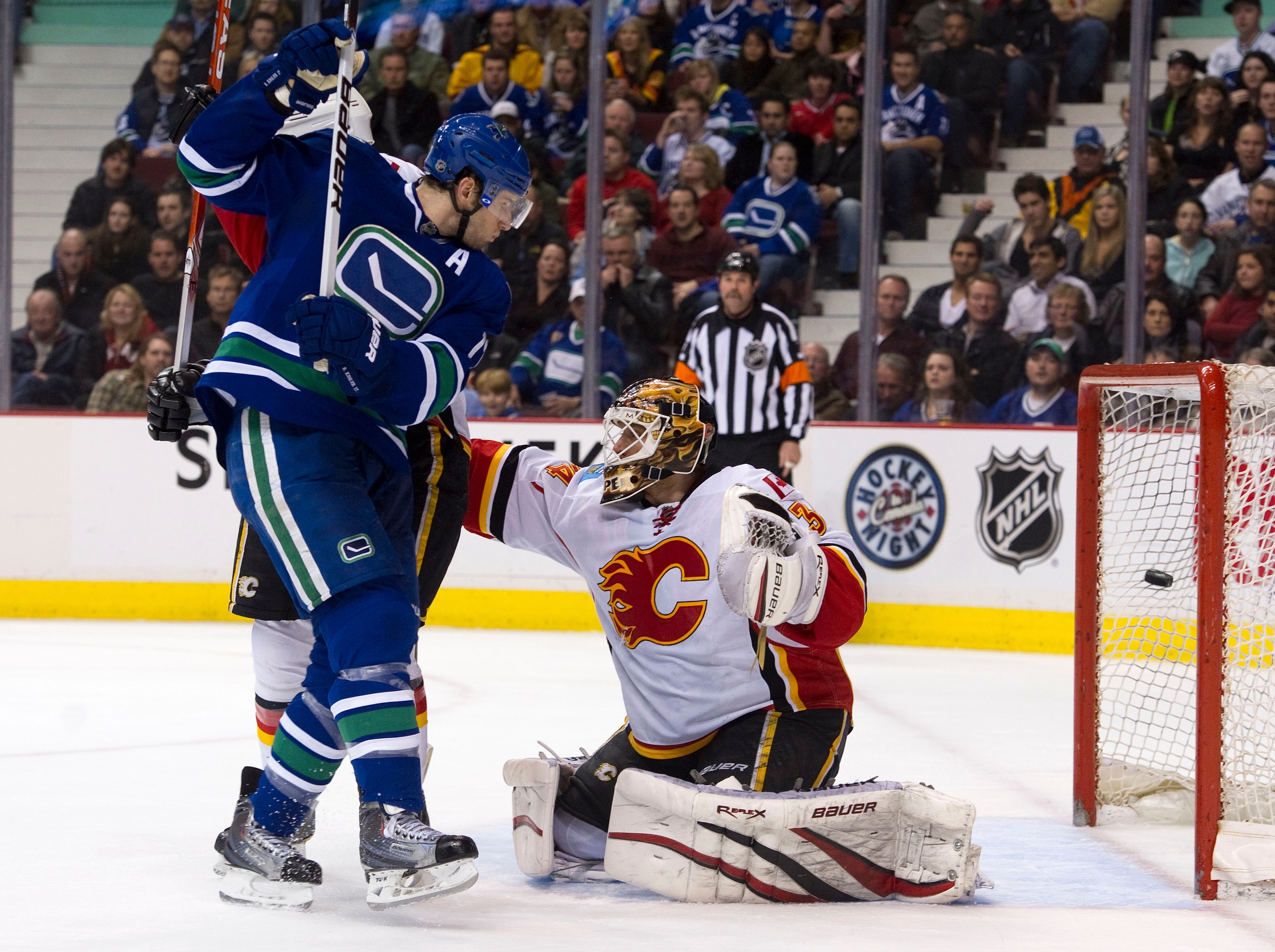 VANCOUVER, CANADA - FEBRUARY 12: Ryan Kesler #17 of the Vancouver Canucks watches teammate Mikael Samuelsson's shot hit the back of the net past goalie Miikka Kiprusoff #34 of the Calgary Flames during the second period in NHL action on February 12, 2011