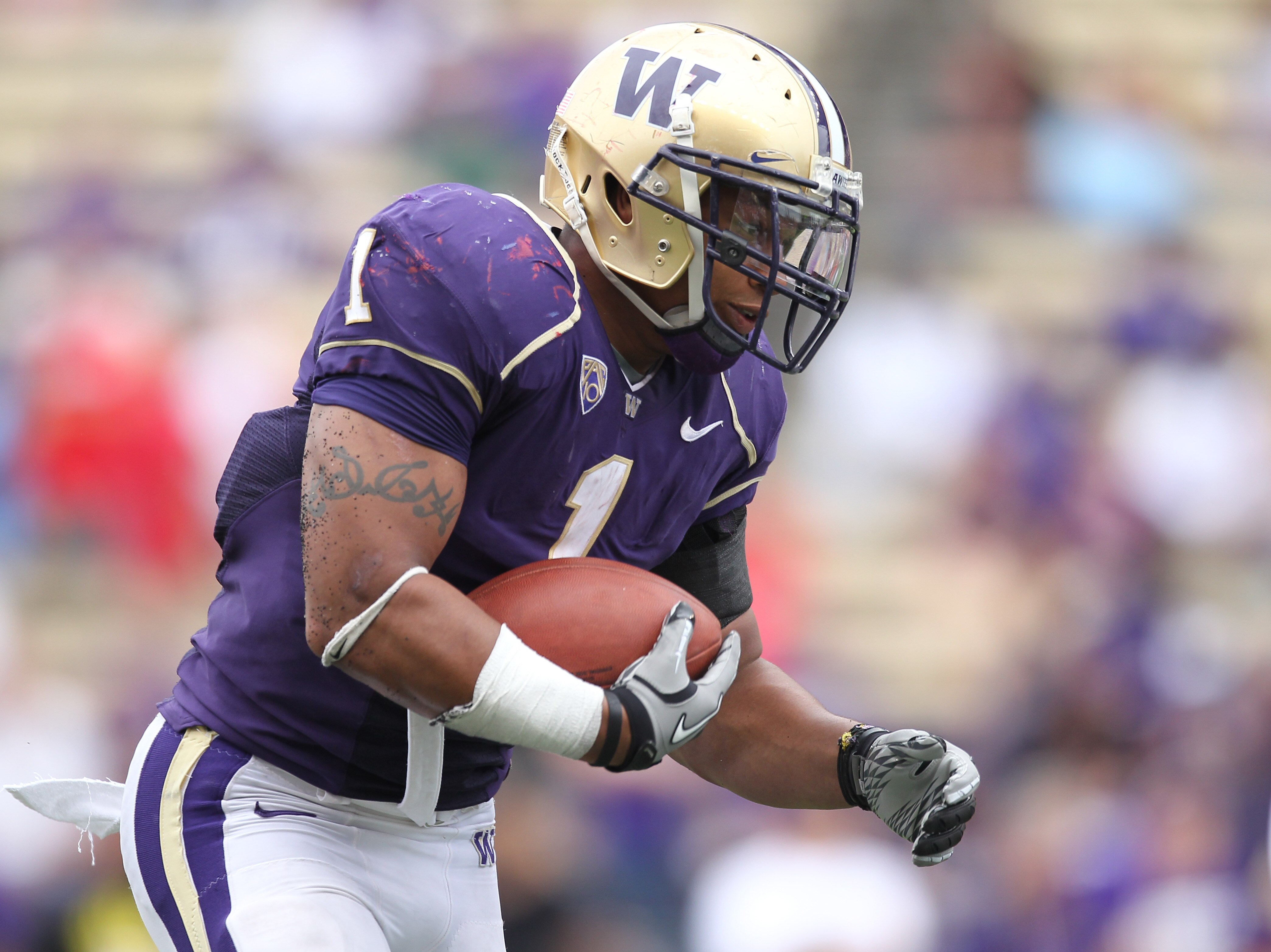 SEATTLE - SEPTEMBER 18: Running back Chris Polk #1 of the Washington Huskies rushes against the Nebraska Cornhuskers on September 18, 2010 at Husky Stadium in Seattle, Washington. (Photo by Otto Greule Jr/Getty Images)