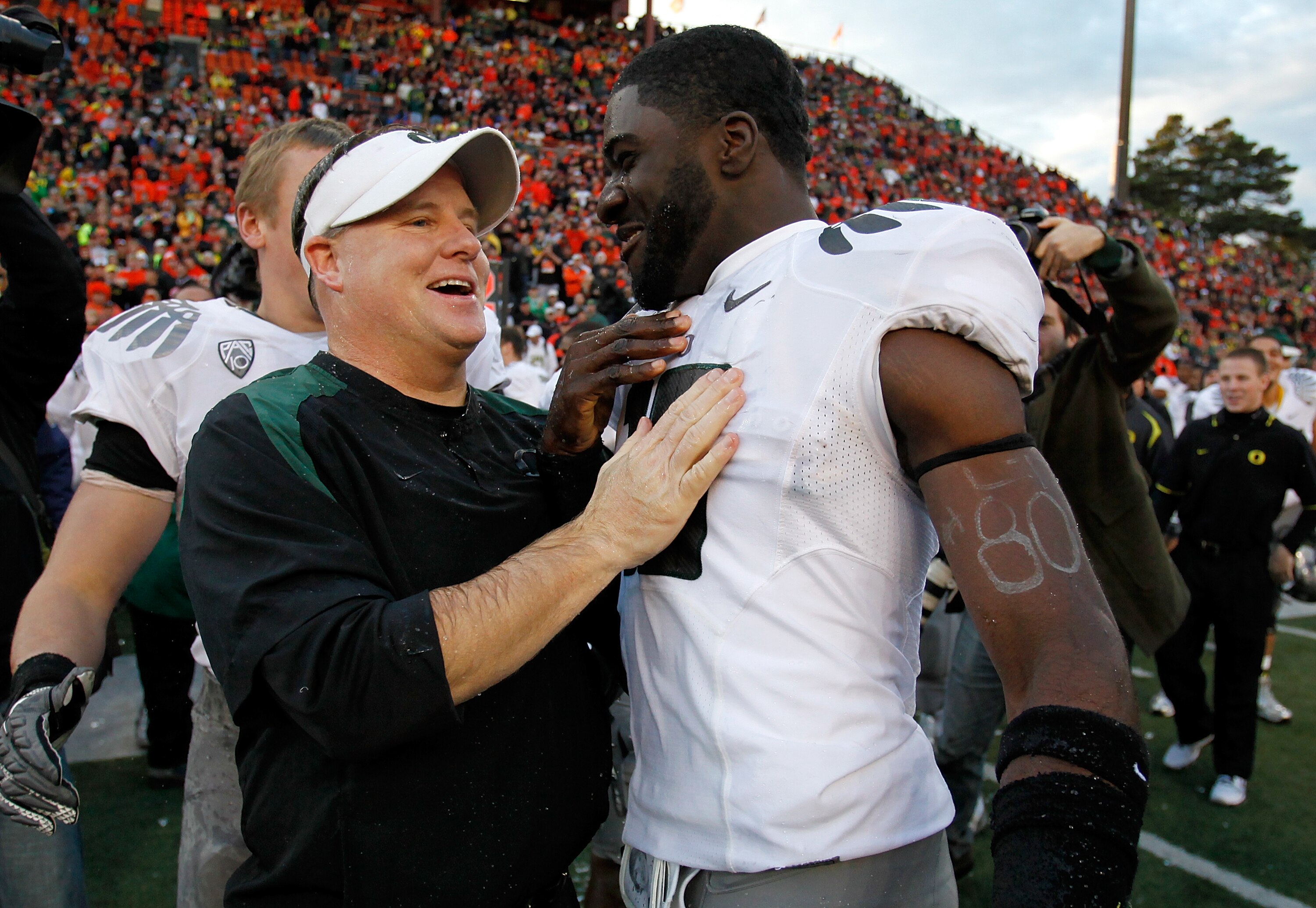 CORVALLIS, OR - DECEMBER 04:  Head Coach Chip Kelly of the Oregon Ducks laughs with Drew Davis #10 after having Gatorade dumped on him after the 37-20 victory over the Oregon State Beavers during the 114th Civil War on December 4, 2010 at the Reser Stadiu