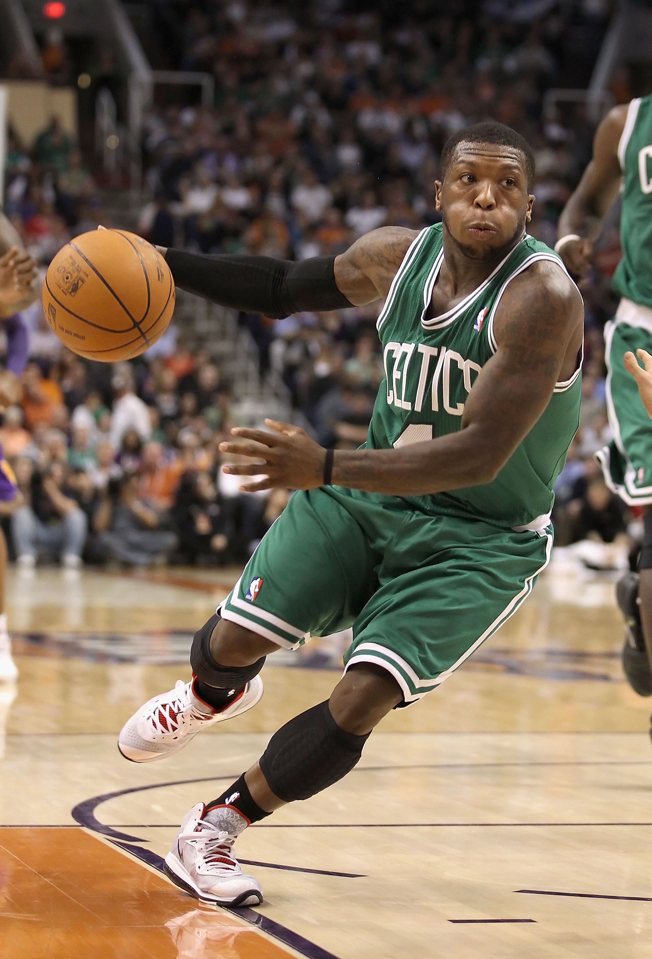 PHOENIX, AZ - JANUARY 28: Nate Robinson #4 of the Boston Celtics handles the ball during the NBA game against the Phoenix Suns at US Airways Center on January 28, 2011 in Phoenix, Arizona. The Suns defeated the Celtics 88-71. NOTE TO USER: User expressly PHOENIX, AZ - JANUARY 28: Nate Robinson #4 of the Boston Celtics handles the ball during the NBA game against the Phoenix Suns at US Airways Center on January 28, 2011 in Phoenix, Arizona. The Suns defeated the Celtics 88-71. NOTE TO USER: User expressly
