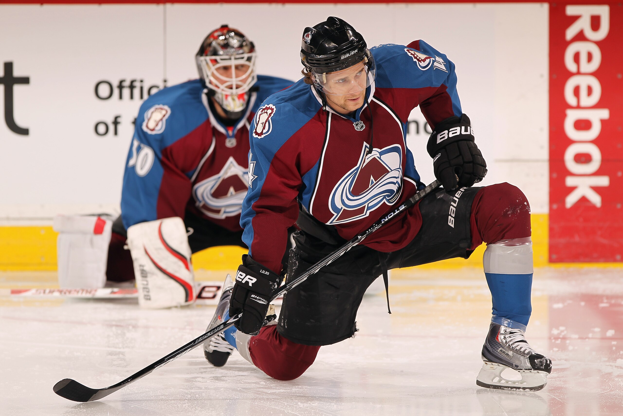 DENVER, CO - FEBRUARY 23:  John-Michael Liles #4 and goalie Brian Elliott #30 of the Colorado Avalanche stretch during warm ups prior to facing the Edmonton Oilers at the Pepsi Center on February 23, 2011 in Denver, Colorado. The Oilers defeated the Avala