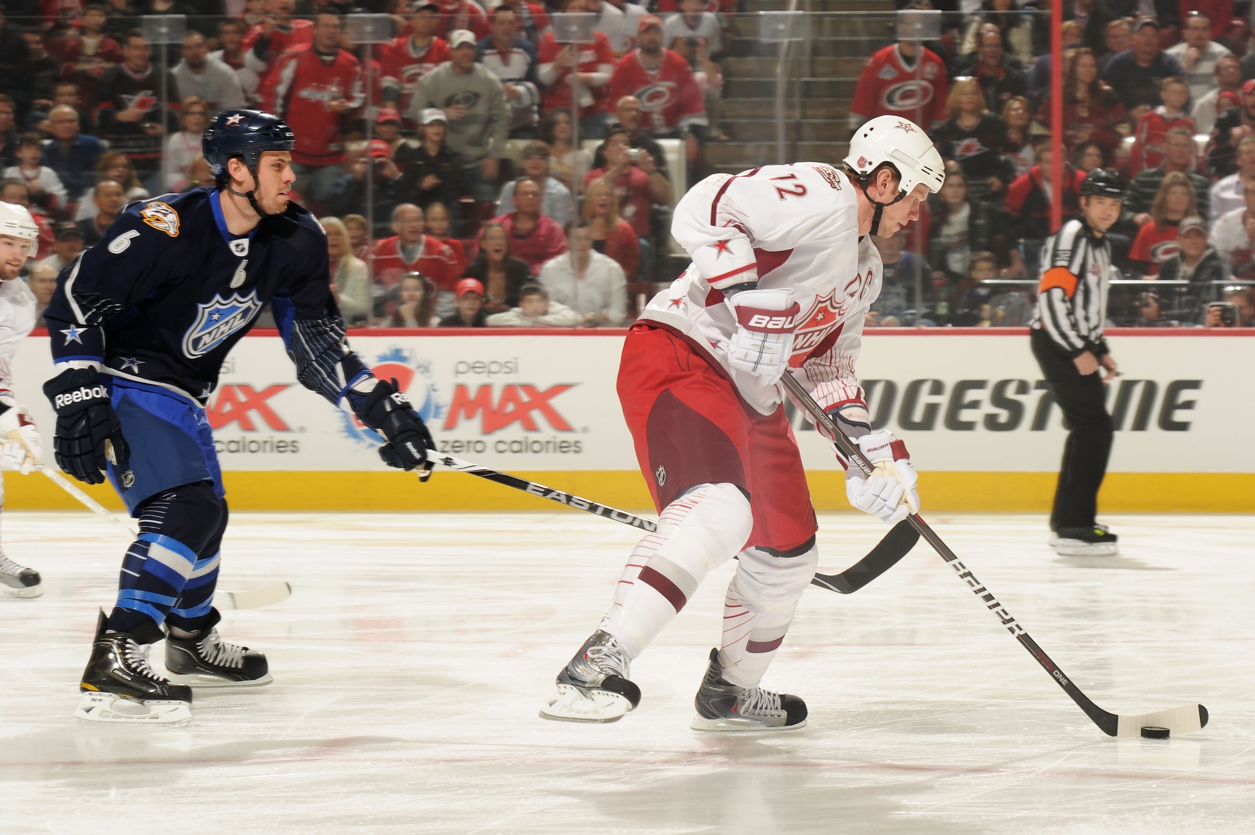 RALEIGH, NC - JANUARY 30:  Eric Staal #12 of the Carolina Hurricanes and Team Staal skates with the puck in front of Shea Weber #6 of the Nashville Predators and Team Lidstrom in the 58th NHL All-Star Game at RBC Center on January 30, 2011 in Raleigh, Nor