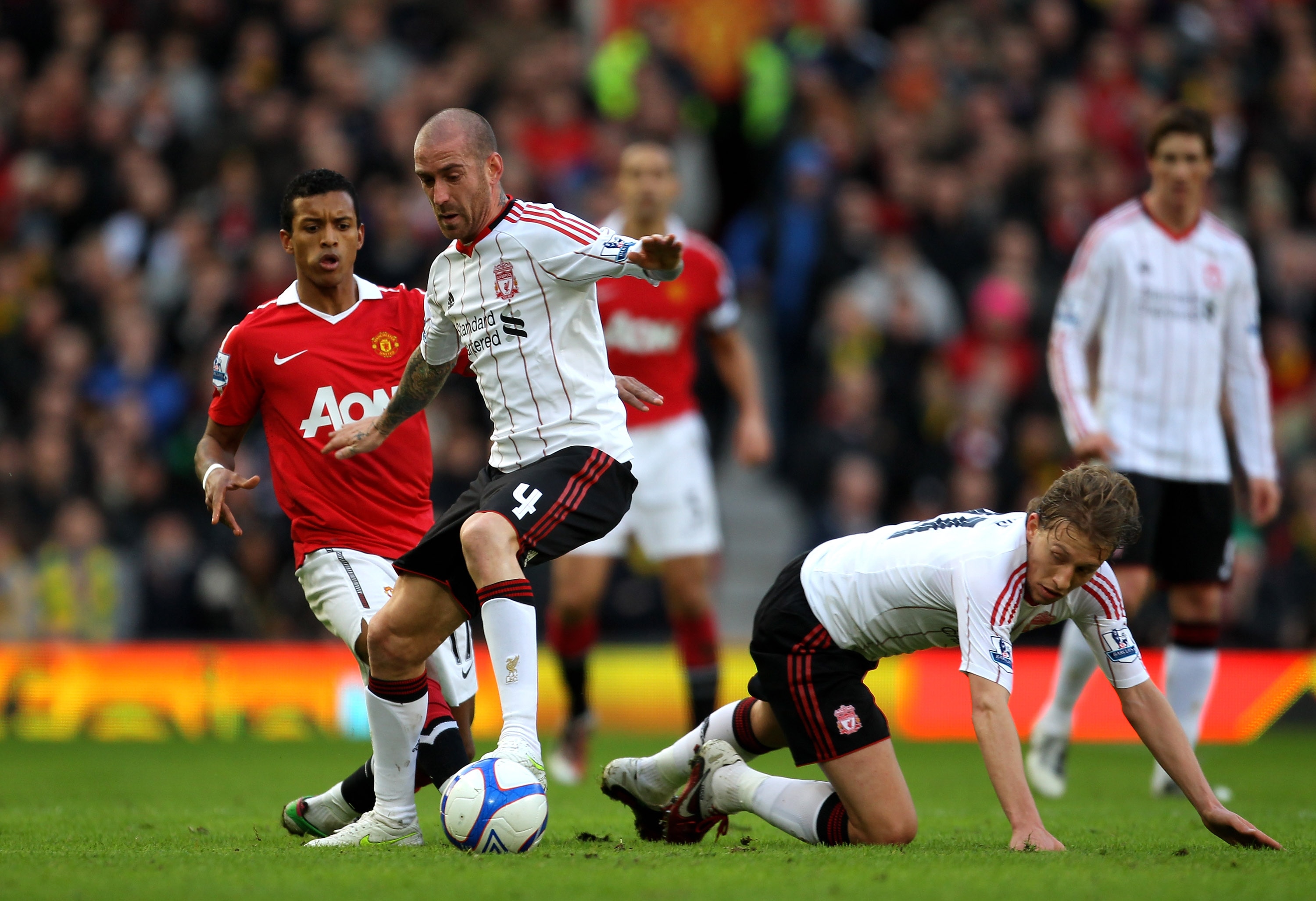 MANCHESTER, ENGLAND - JANUARY 09:   Raul Meireles and Lucas (R) of Liverpool compete with Nani of Manchester United during the FA Cup sponsored by E.ON 3rd round match between Manchester United and Liverpool at Old Trafford on January 9, 2011 in Mancheste