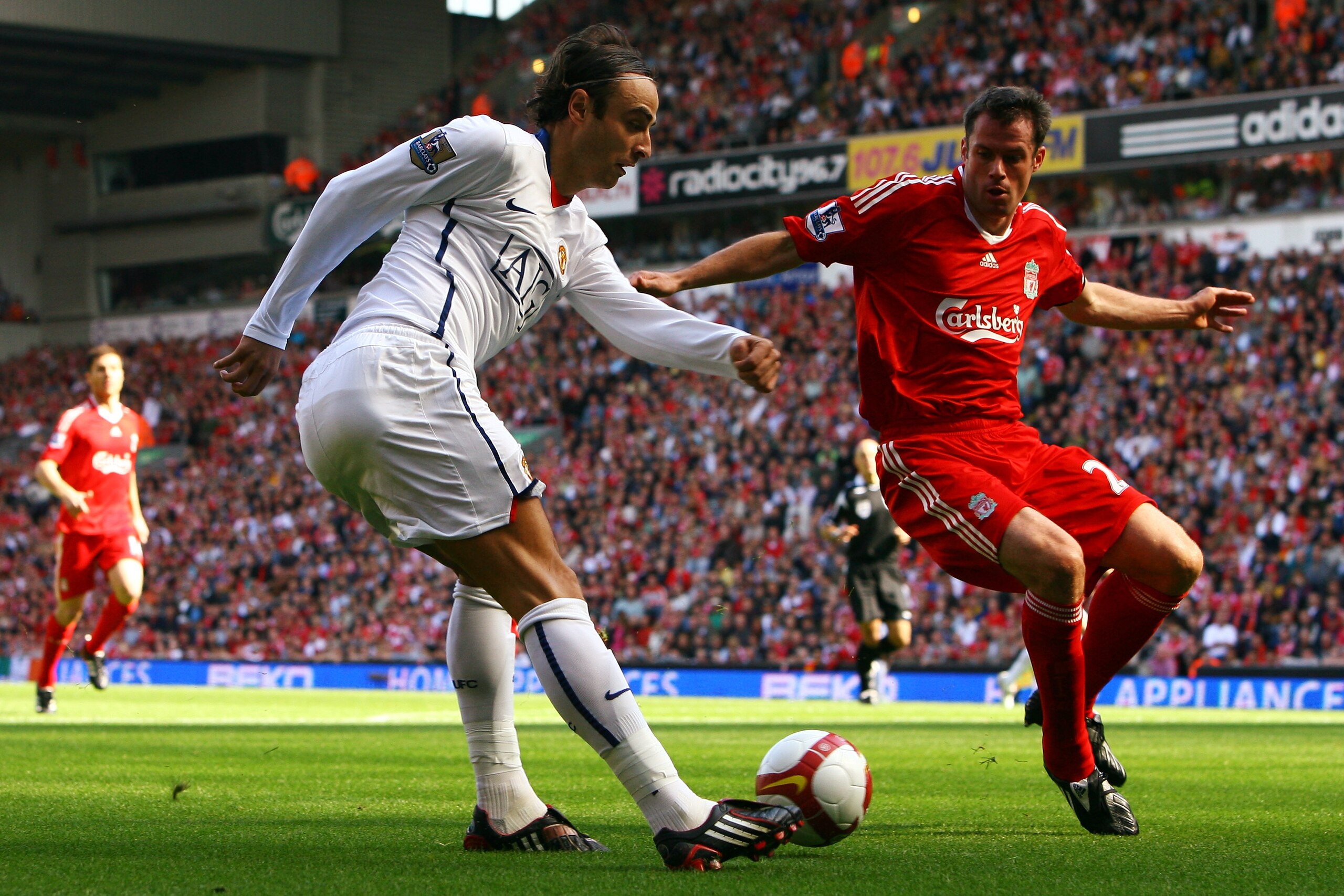 LIVERPOOL, UNITED KINGDOM - SEPTEMBER 13: Dimitar Berbatov of Manchester United crosses the ball behind Jamie Carragher of Liverpool for Carlos Tevez to score during Barclays Preimier League match between Liverpool and Manchester United at Anfield on Sept