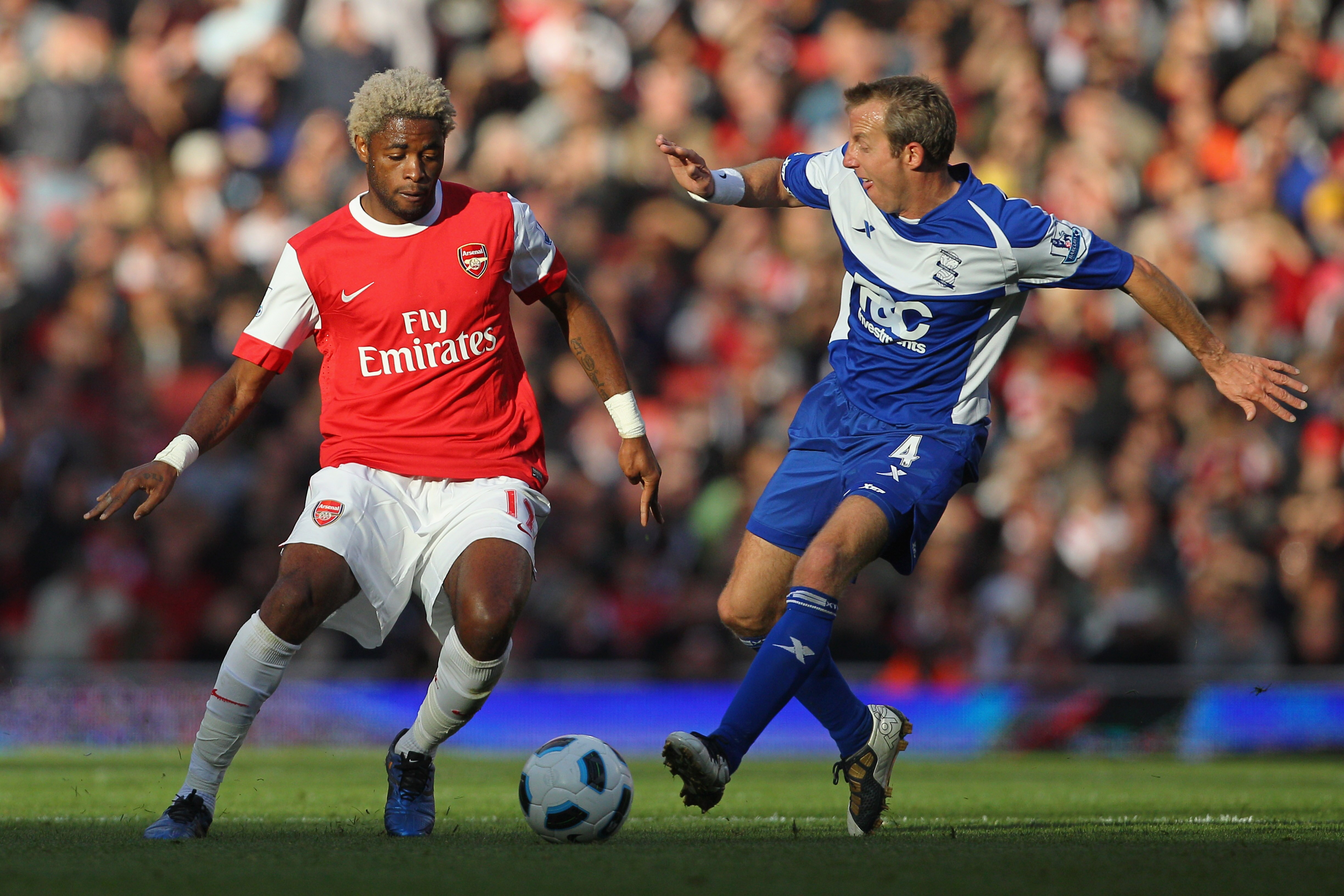 LONDON, ENGLAND - OCTOBER 16:  Alex Song of Arsenal is challenged by Lee Bowyer of Birmingham City during the Barclays Premier League match between Arsenal and Birmingham City at Emirates Stadium on October 16, 2010 in London, England.  (Photo by Clive Ro