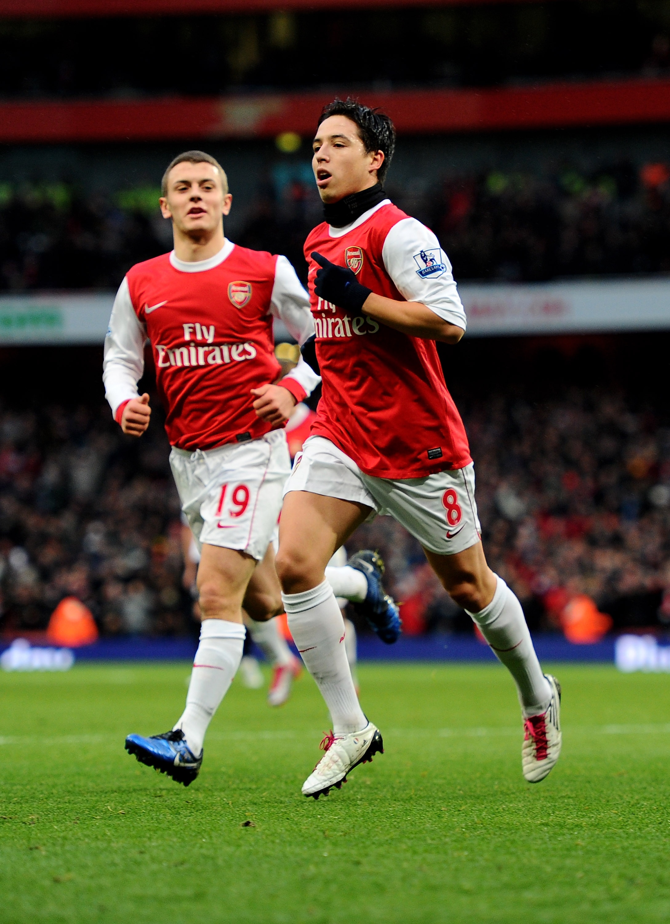 LONDON, ENGLAND - DECEMBER 04:  Samir Nasri (L) of Arsenal celebrates with teammate Jack Wilshere after scoring the opening goal during the Barclays Premier League match between Arsenal and Fulham at the Emirates Stadium on December 4, 2010 in London, Eng