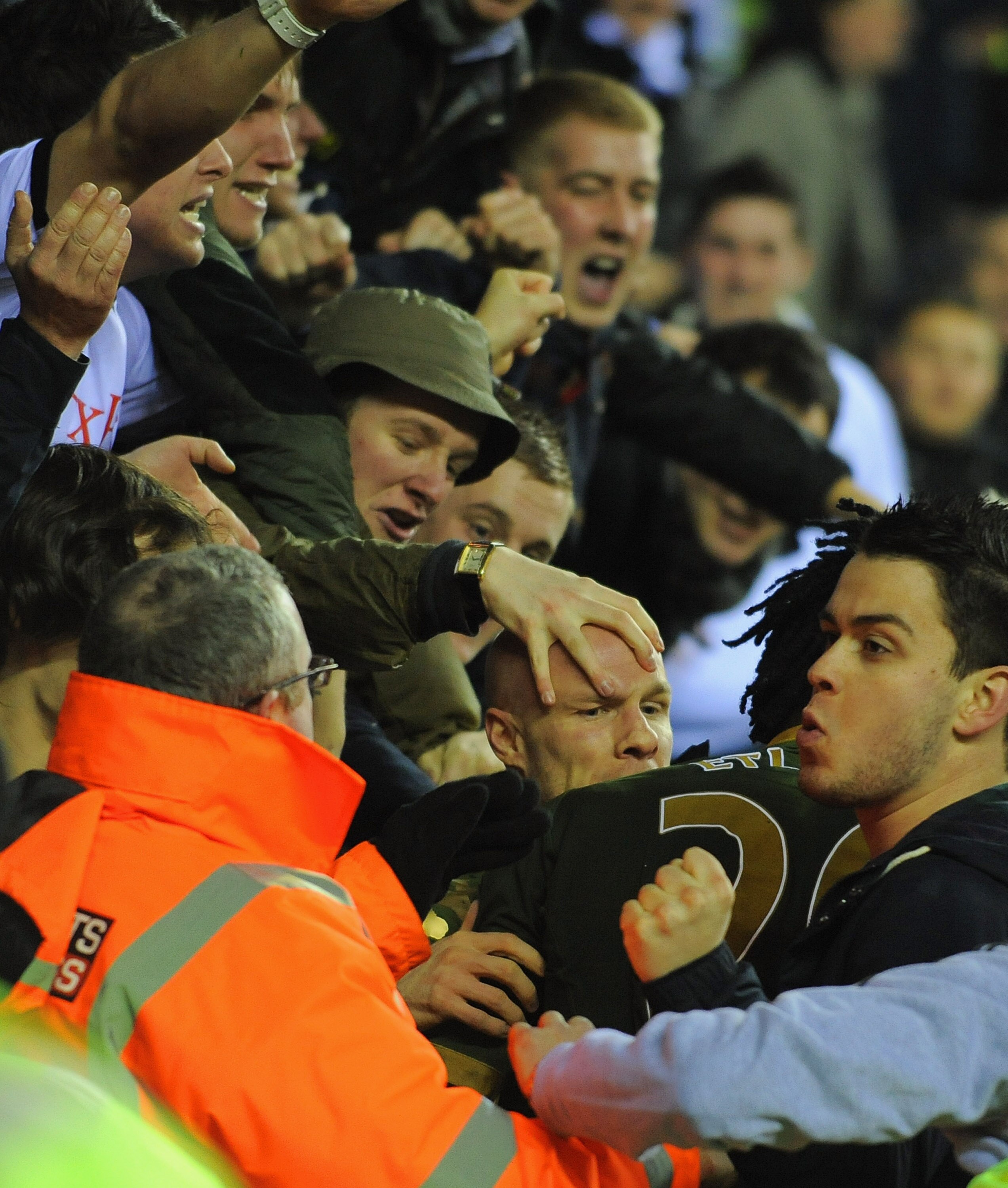WIGAN, ENGLAND - JANUARY 15:  Andy Johnson of Fulham is mobbed by team mates, fans and stewards as he celebrates scoring to make it 1-1 during the Premier League match between Wigan Athletic and Fulham at the DW Stadium on January 15, 2011 in Wigan, Engla