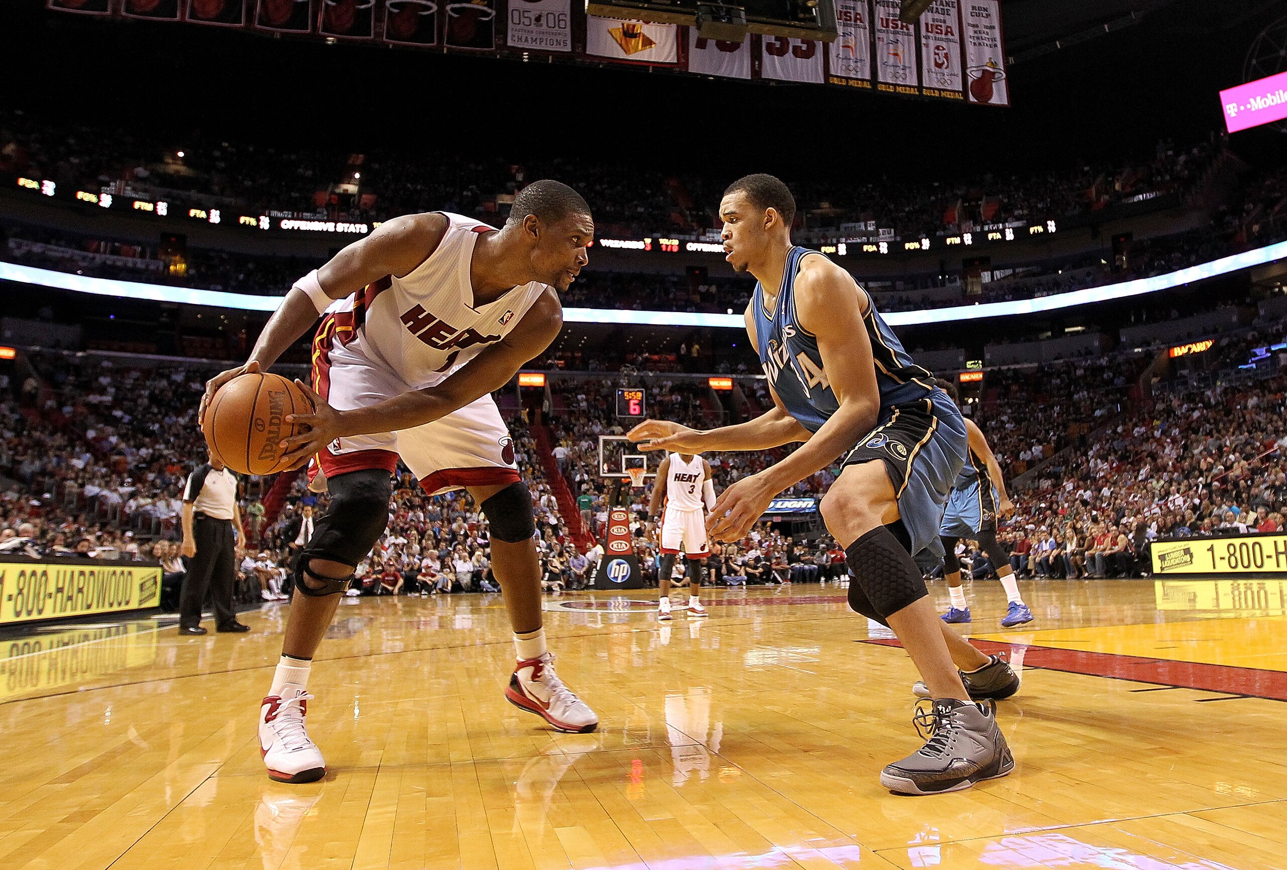 MIAMI, FL - FEBRUARY 25:  Chris Bosh #1 of the Miami Heat posts up JaVale McGee #34 of the Washington Wizards during a game at American Airlines Arena on February 25, 2011 in Miami, Florida. NOTE TO USER: User expressly acknowledges and agrees that, by do