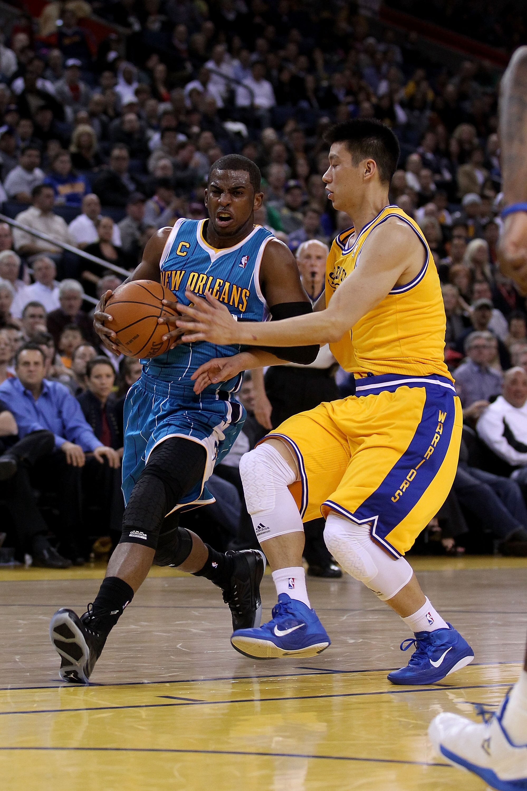 OAKLAND, CA - FEBRUARY 15:  Chris Paul #3 of the New Orleans Hornets drives on Jeremy Lin #7 of the Golden State Warriors at Oracle Arena on February 15, 2011 in Oakland, California. NOTE TO USER: User expressly acknowledges and agrees that, by downloadin