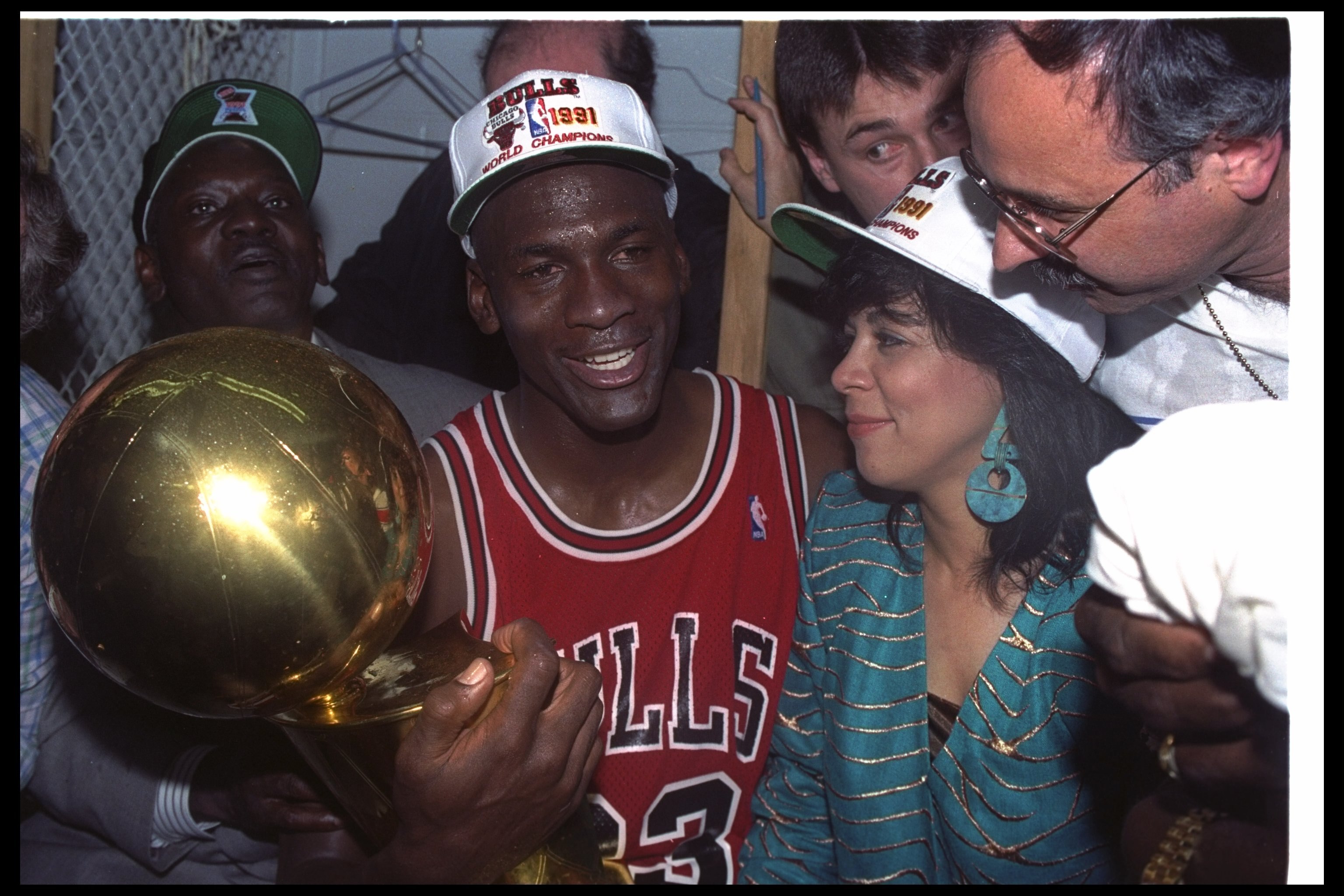 Guard Michael Jordan of the Chicago Bulls celebrates with his wife and the NBA trophy after the Bulls won the NBA championship.