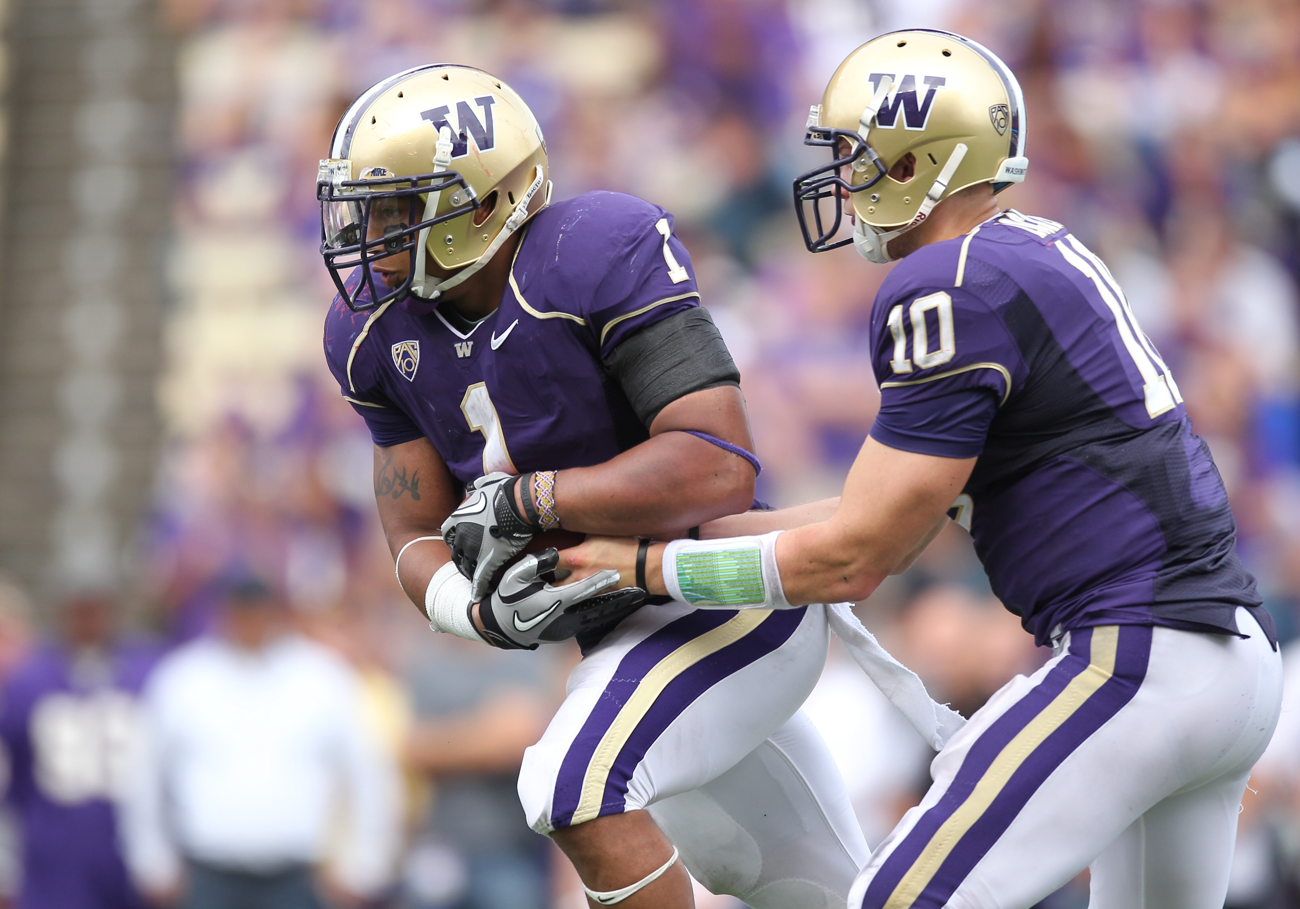 SEATTLE - SEPTEMBER 18: Quarterback Jake Locker #10 of the Washington Huskies hands off to Chris Polk #1 during the game against the Nebraska Cornhuskers on September 18, 2010 at Husky Stadium in Seattle, Washington. (Photo by Otto Greule Jr/Getty Images)