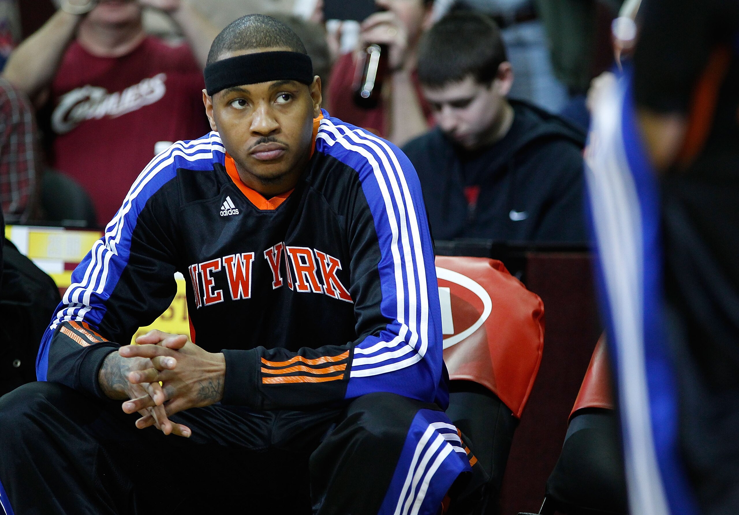 CLEVELAND - FEBRUARY 25: Carmelo Anthony #7 of the New York Knicks sits on the bench prior to introductions before the game against the Cleveland Cavalierson February 25, 2011 at Quicken Loans Arena in Cleveland, Ohio. NOTE TO USER: User expressly acknow CLEVELAND - FEBRUARY 25: Carmelo Anthony #7 of the New York Knicks sits on the bench prior to introductions before the game against the Cleveland Cavalierson February 25, 2011 at Quicken Loans Arena in Cleveland, Ohio. NOTE TO USER: User expressly acknow