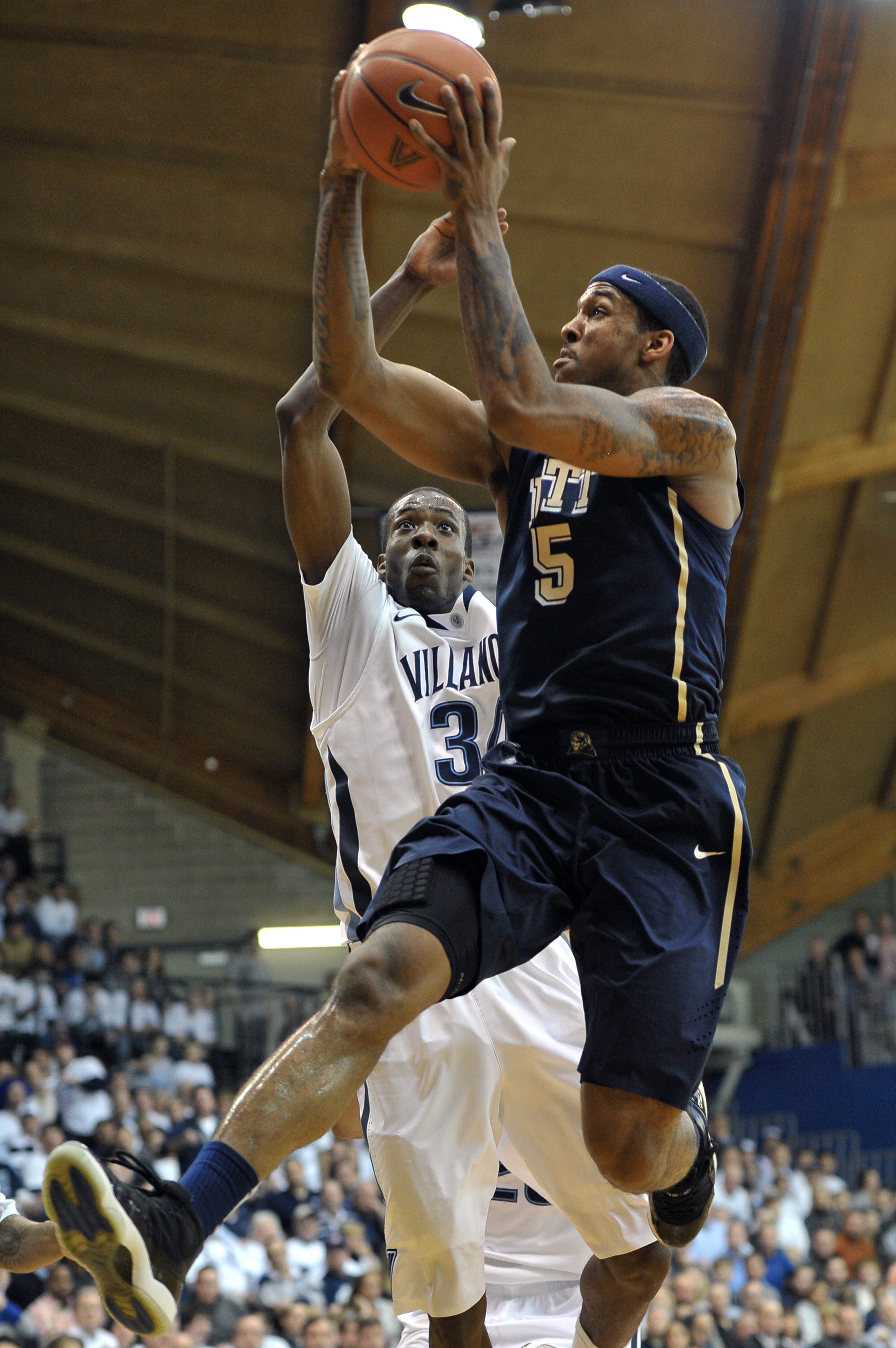 VILLANOVA, PA - FEBRUARY 12: Gilbert Brown #5 of the Pittsburgh Panthers lays up a shot past Isaiah Armwood #34 of the Villanova Wildcats at The Pavilion on February 12, 2011 in Villanova, Pennsylvania (Photo by Drew Hallowell/Getty Images)