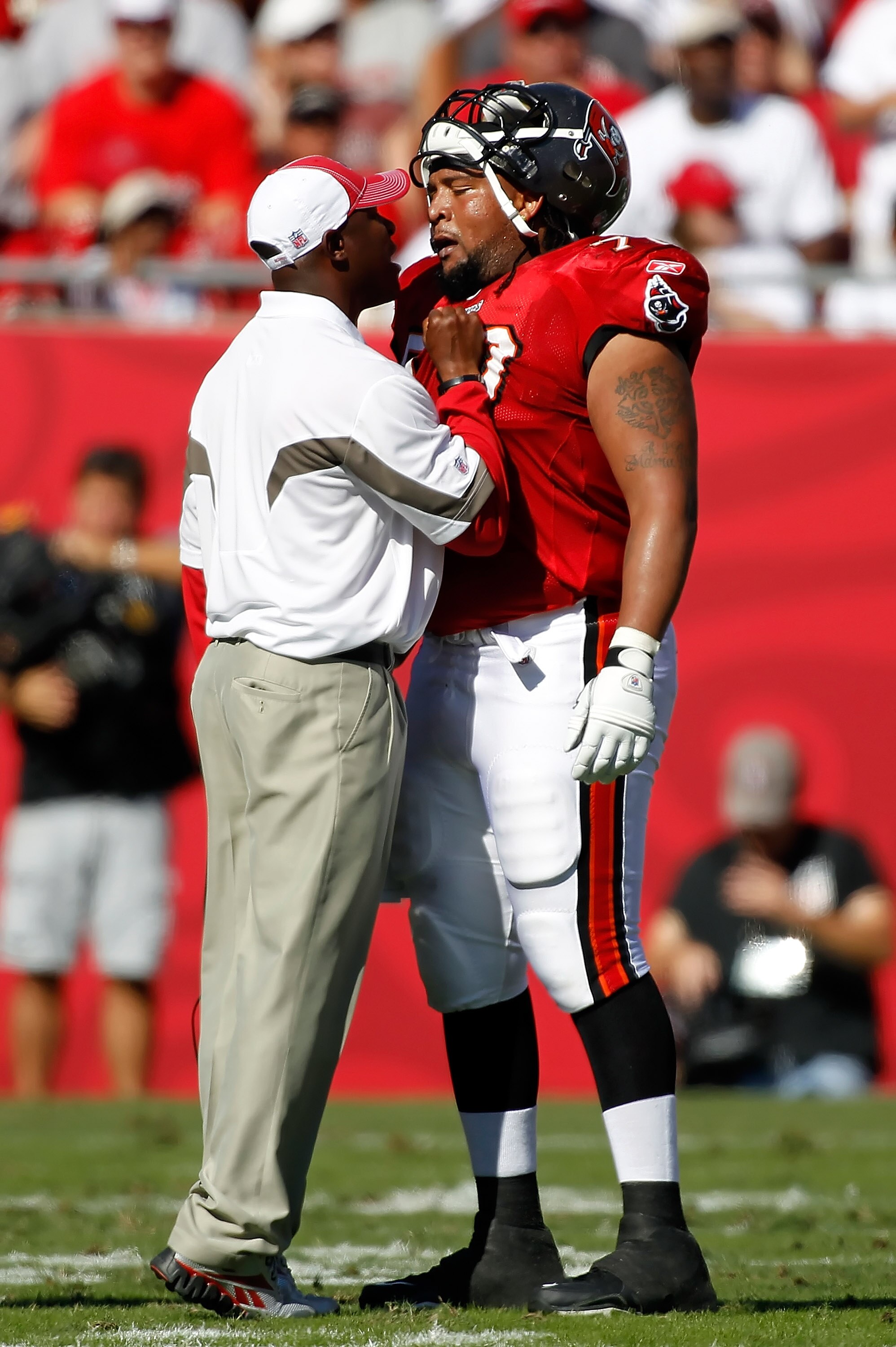 TAMPA, FL - NOVEMBER 14:  Head coach Raheem Morris of the Tampa Bay Buccaneers has some words for offensive lineman Donald Penn #70 during the game against the Carolina Panthers at Raymond James Stadium on November 14, 2010 in Tampa, Florida.  (Photo by J