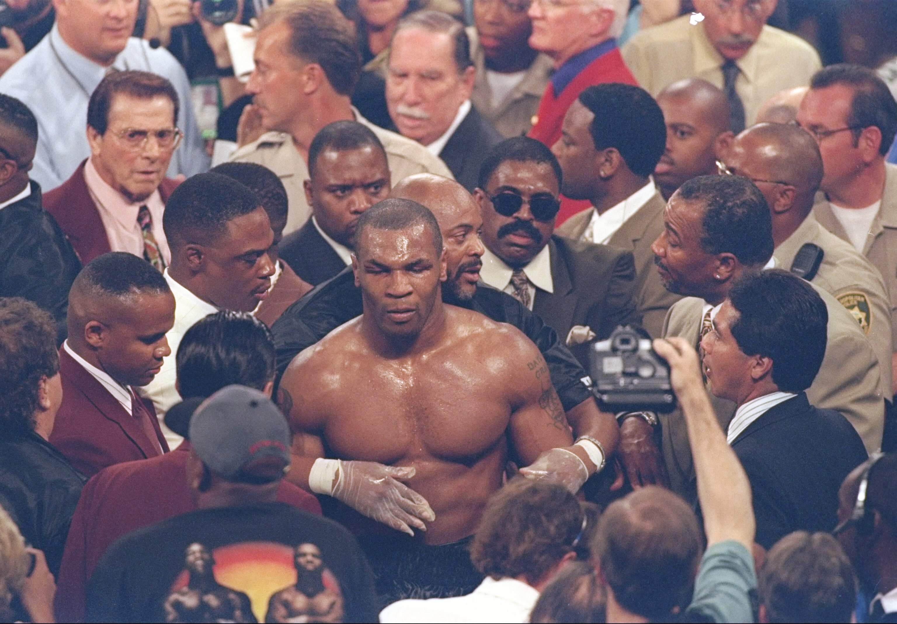 28 Jun 1997: Mike Tyson makes his way back to the dressing room through the crowd after losing his heavyweight title fight against Evander Holyfield at the MGM Grand Garden in Las Vegas, Nevada. Holyfield won the fight when referee Mills Lane disqualified