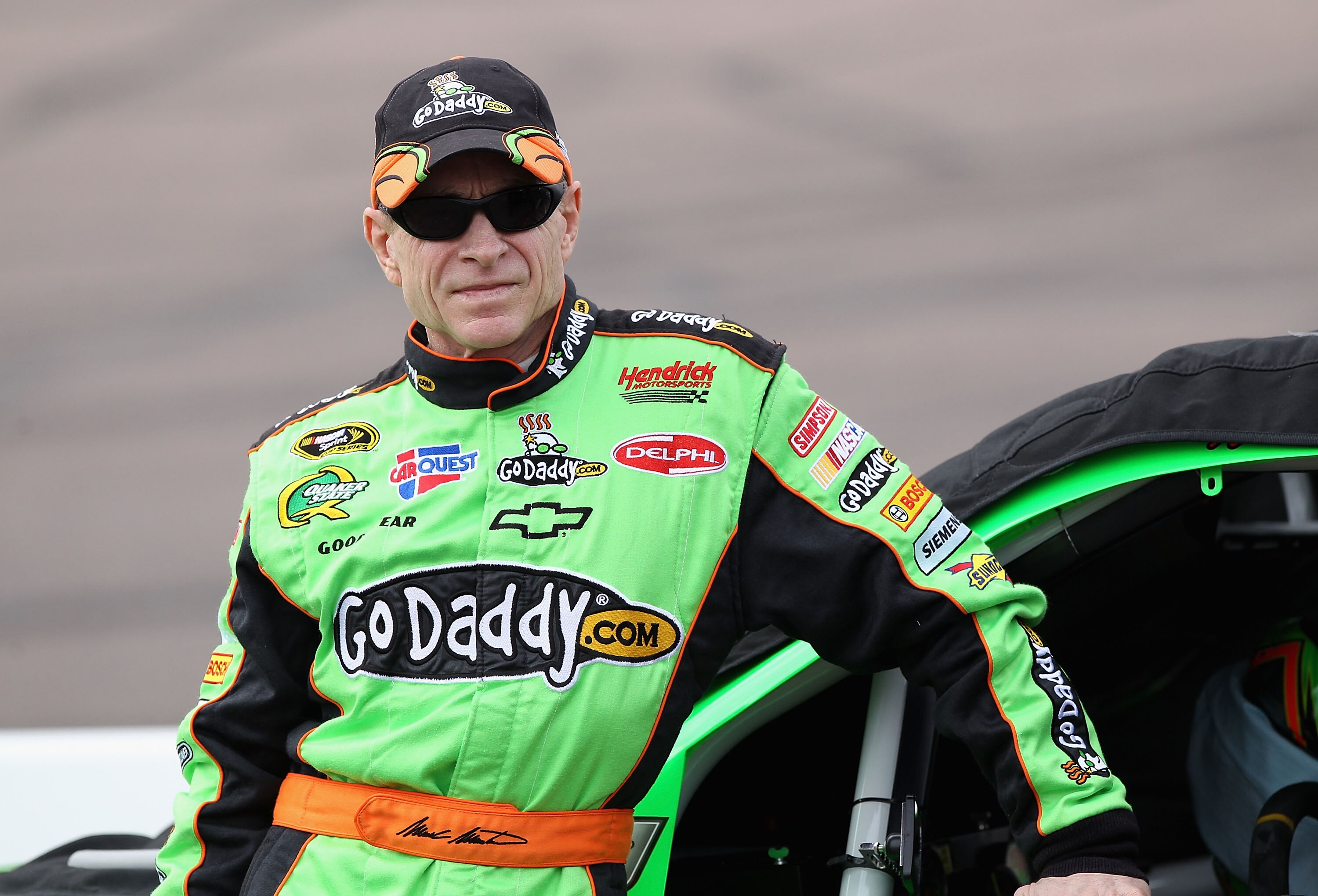 AVONDALE, AZ - FEBRUARY 26:  Mark Martin, driver of the #5 GoDaddy.com Chevrolet, stands on pit road during qualifying for the NASCAR Sprint Cup Series Subway Fresh Fit 500 at Phoenix International Raceway on February 26, 2011 in Avondale, Arizona.  (Phot