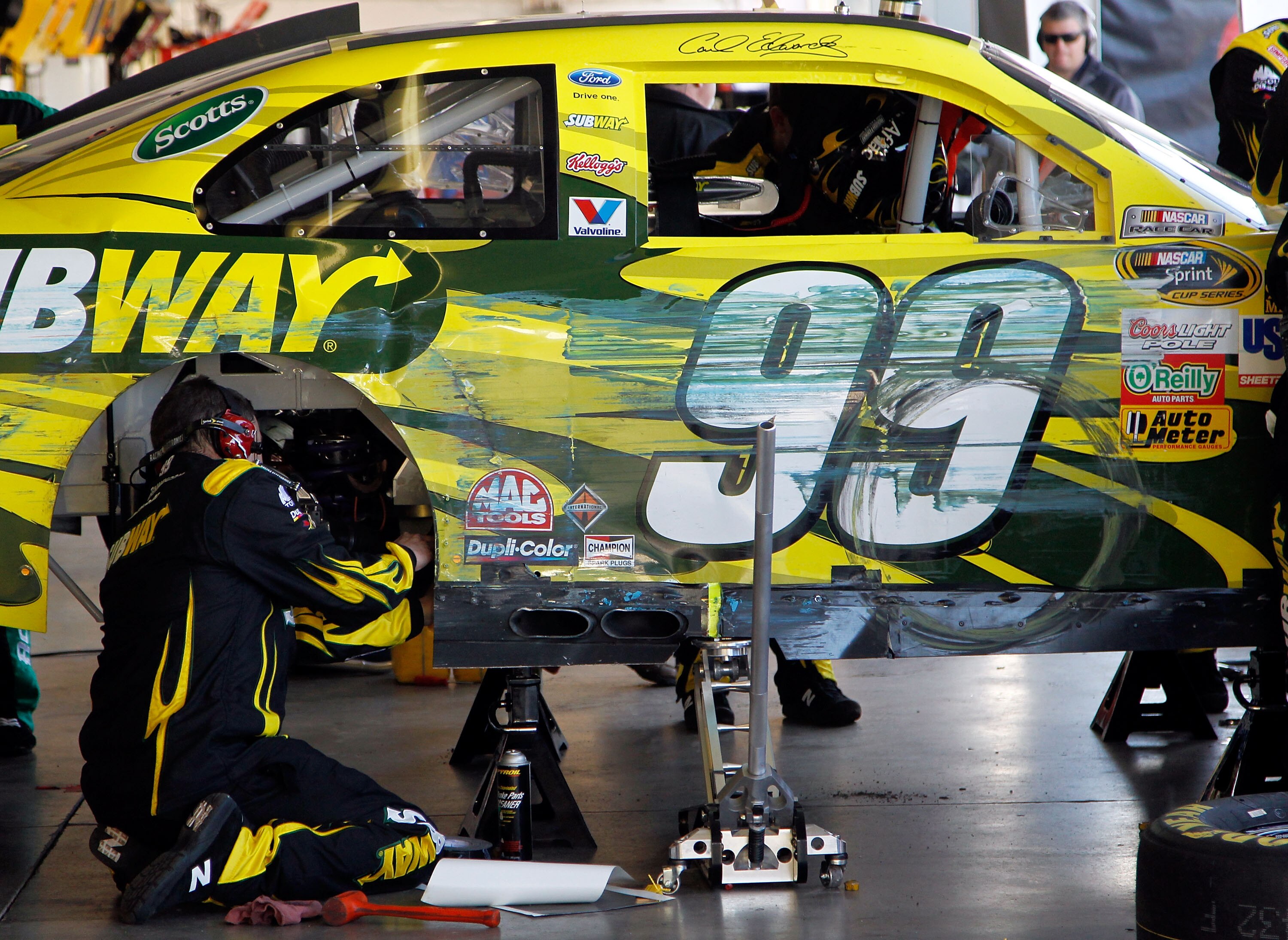 AVONDALE, AZ - FEBRUARY 27:  Crew members work on the car of Carl Edwards, driver of the #99 Subway Ford, after crashing during the NASCAR Sprint Cup Series Subway Fresh Fit 500 at Phoenix International Raceway on February 27, 2011 in Avondale, Arizona.