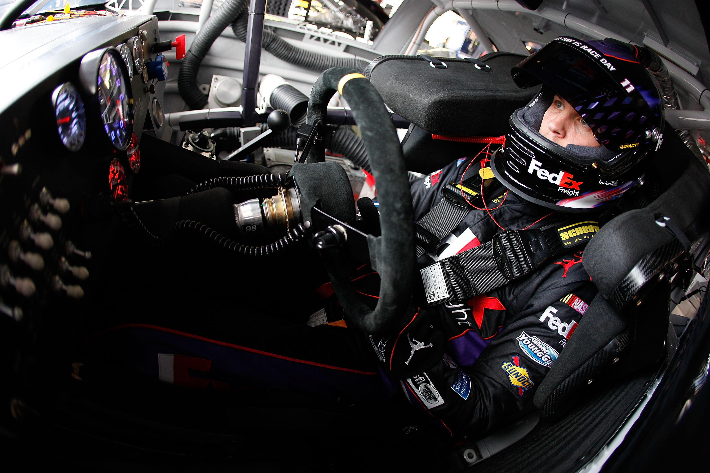 AVONDALE, AZ - FEBRUARY 25:  Denny Hamlin, driver of the #11 FedEx Toyota, sits in his car during practice for the Subway Fresh Fit 500 at Phoenix International Raceway on February 25, 2011 in Avondale, Arizona.  (Photo by Chris Graythen/Getty Images)