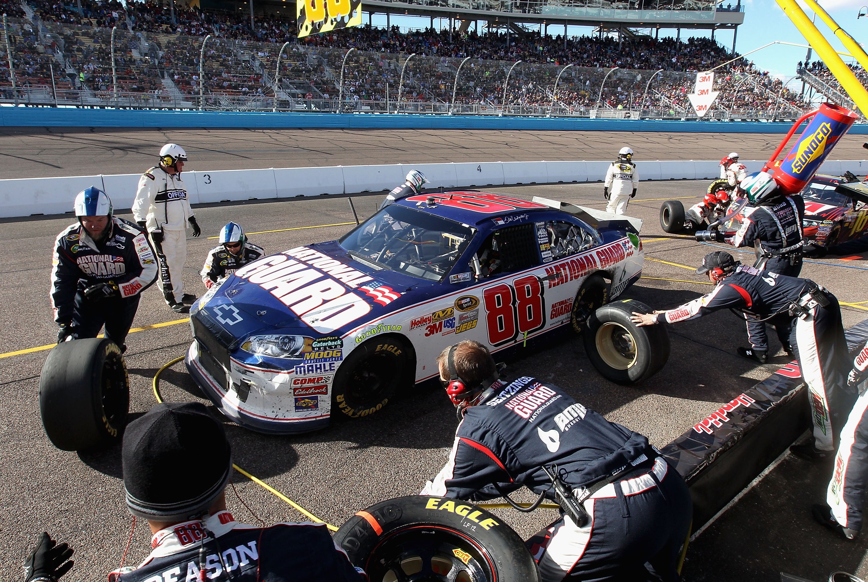 AVONDALE, AZ - FEBRUARY 27:  Dale Earnhardt Jr., driver of the #88 National Guard/AMP Energy Chevrolet, makes a pit stop during the NASCAR Sprint Cup Series Subway Fresh Fit 500 at Phoenix International Raceway on February 27, 2011 in Avondale, Arizona.