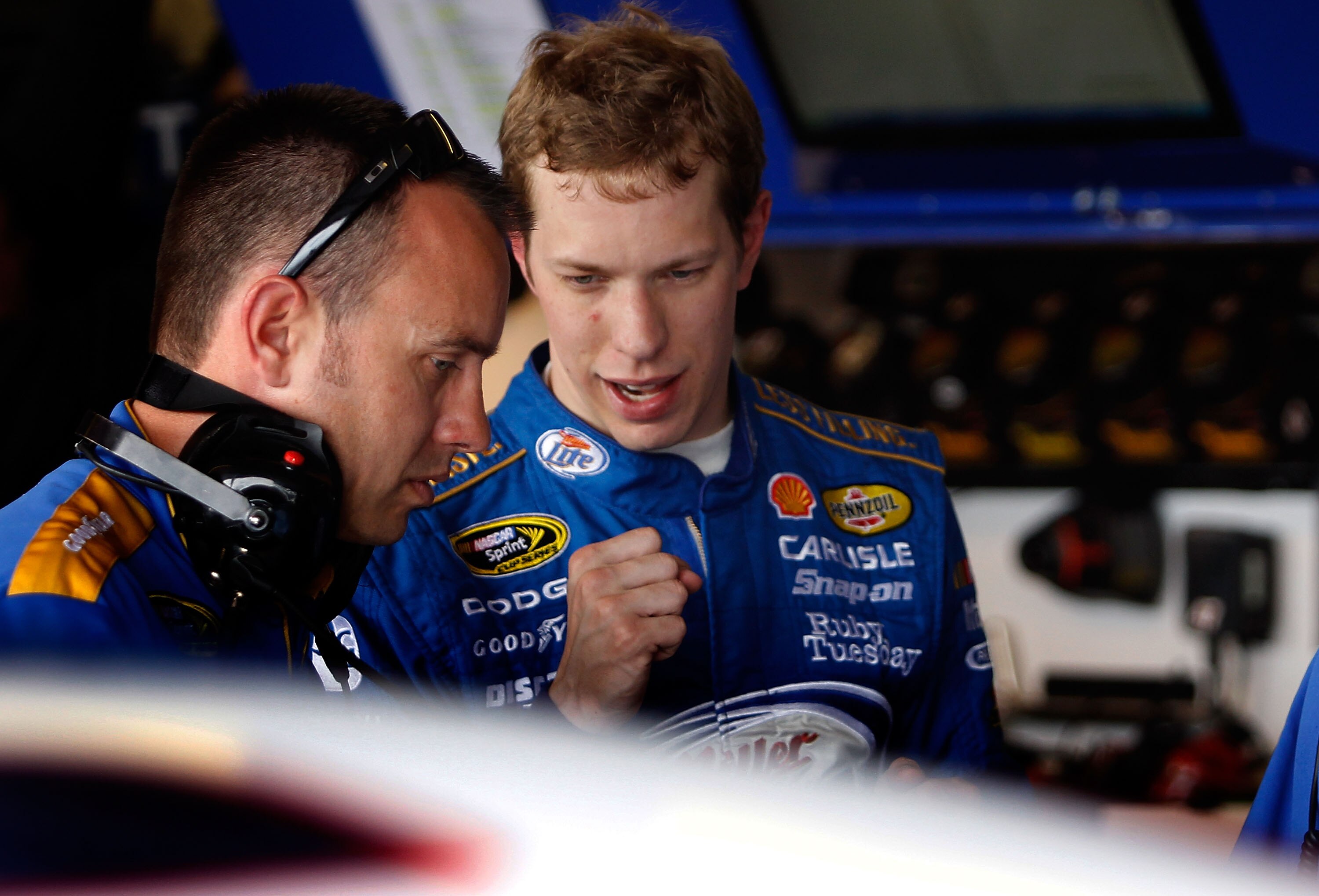AVONDALE, AZ - FEBRUARY 25:  Brad Keselowski, driver of the #2 Miller Lite Dodge, speaks with a crew member during practice for the Subway Fresh Fit 500 at Phoenix International Raceway on February 25, 2011 in Avondale, Arizona.  (Photo by Tom Pennington/