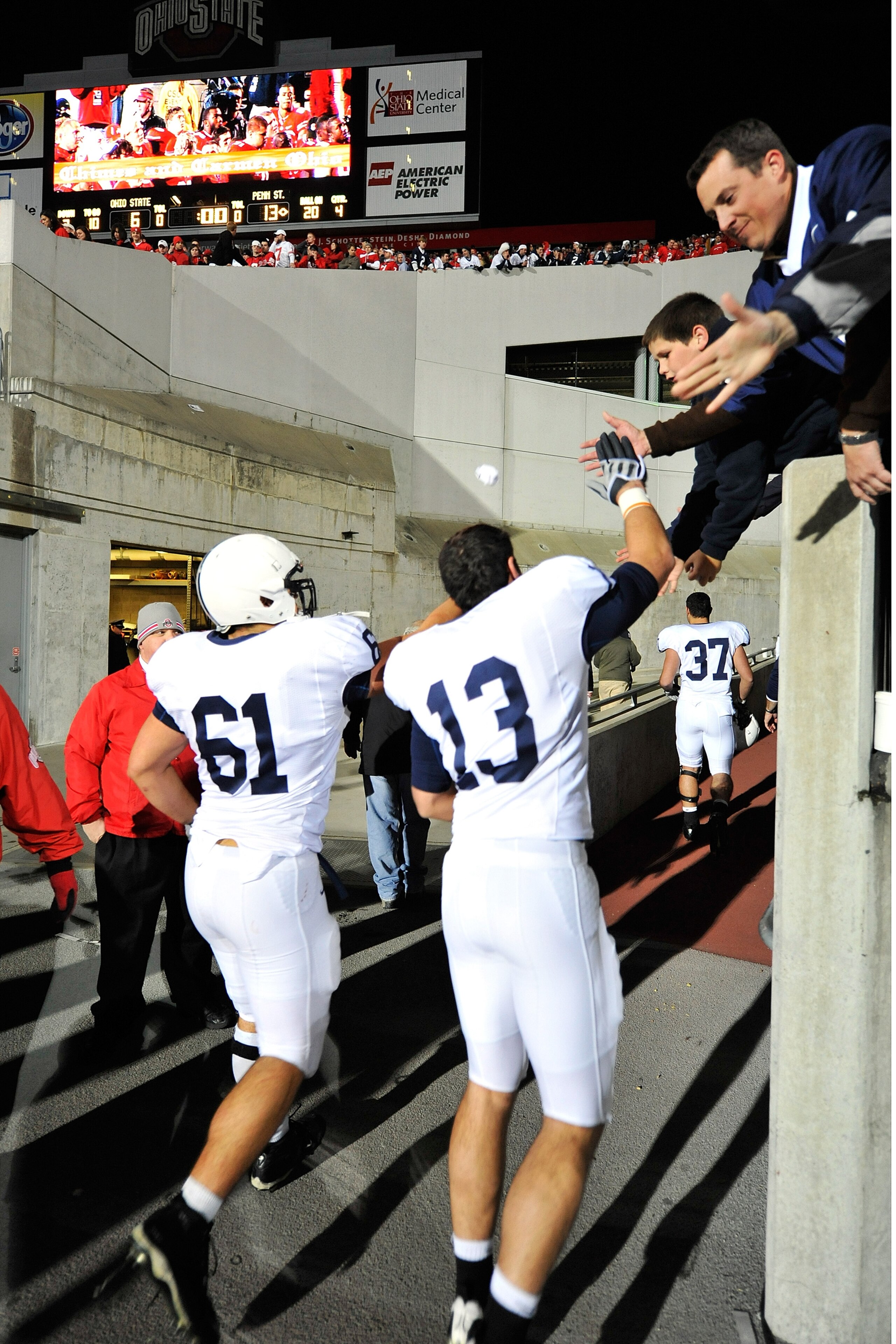 COLUMBUS, OH - OCTOBER 25: Stefen Wisniewski #61 and Andrew Dailey #13 of the Penn State Nittany Lions get congratulations from fans as they head to the locker room after defeating the Ohio State Buckeyes 13-6 on October 25, 2008 at Ohio Stadium in Columb