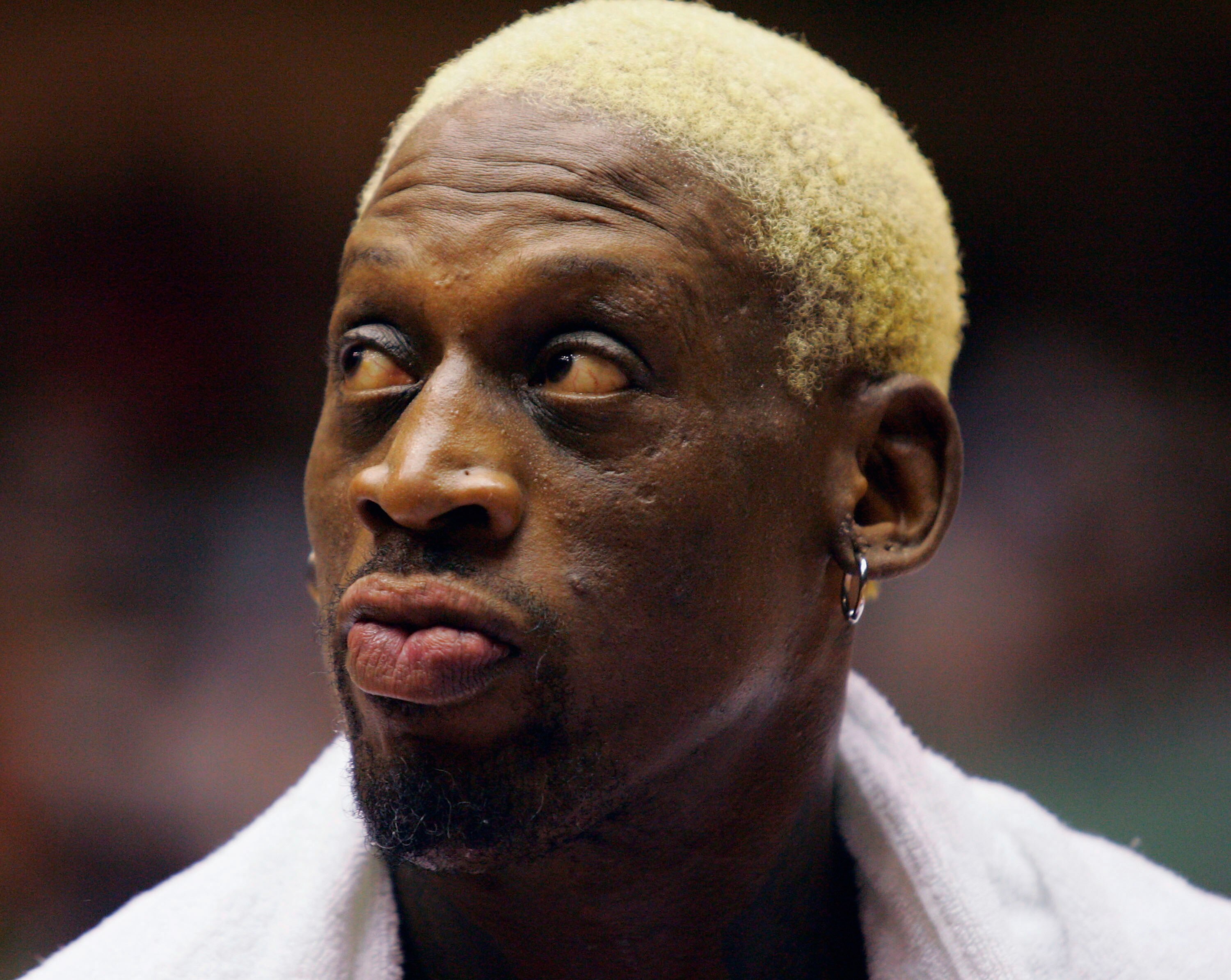 WUHAN, CHINA - AUGUST 12: (CHINA OUT) Former NBA star Dennis Rodman rests during an exhibition match between former NBA players and the US university students All-star Team on August 12, 2005 in Wuhan of Hubei Province, central China. Dennis Rodman is vis