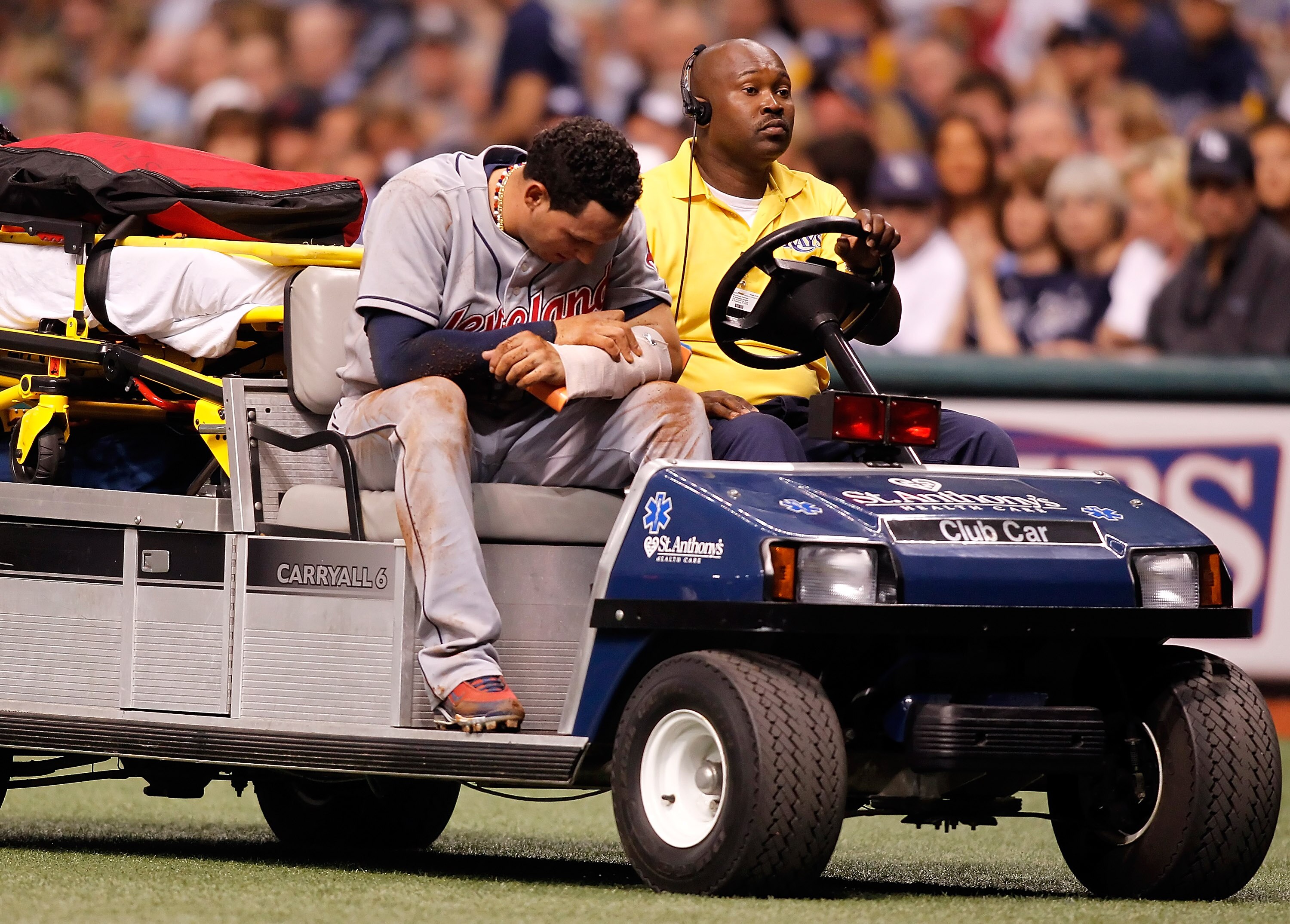 ST PETERSBURG, FL - MAY 17:  Shortstop Asdrubal Cabrera #13 of the Cleveland Indians is helped from the field after an injury to his left arm against the Tampa Bay Rays during the game at Tropicana Field on May 17, 2010 in St. Petersburg, Florida.  (Photo