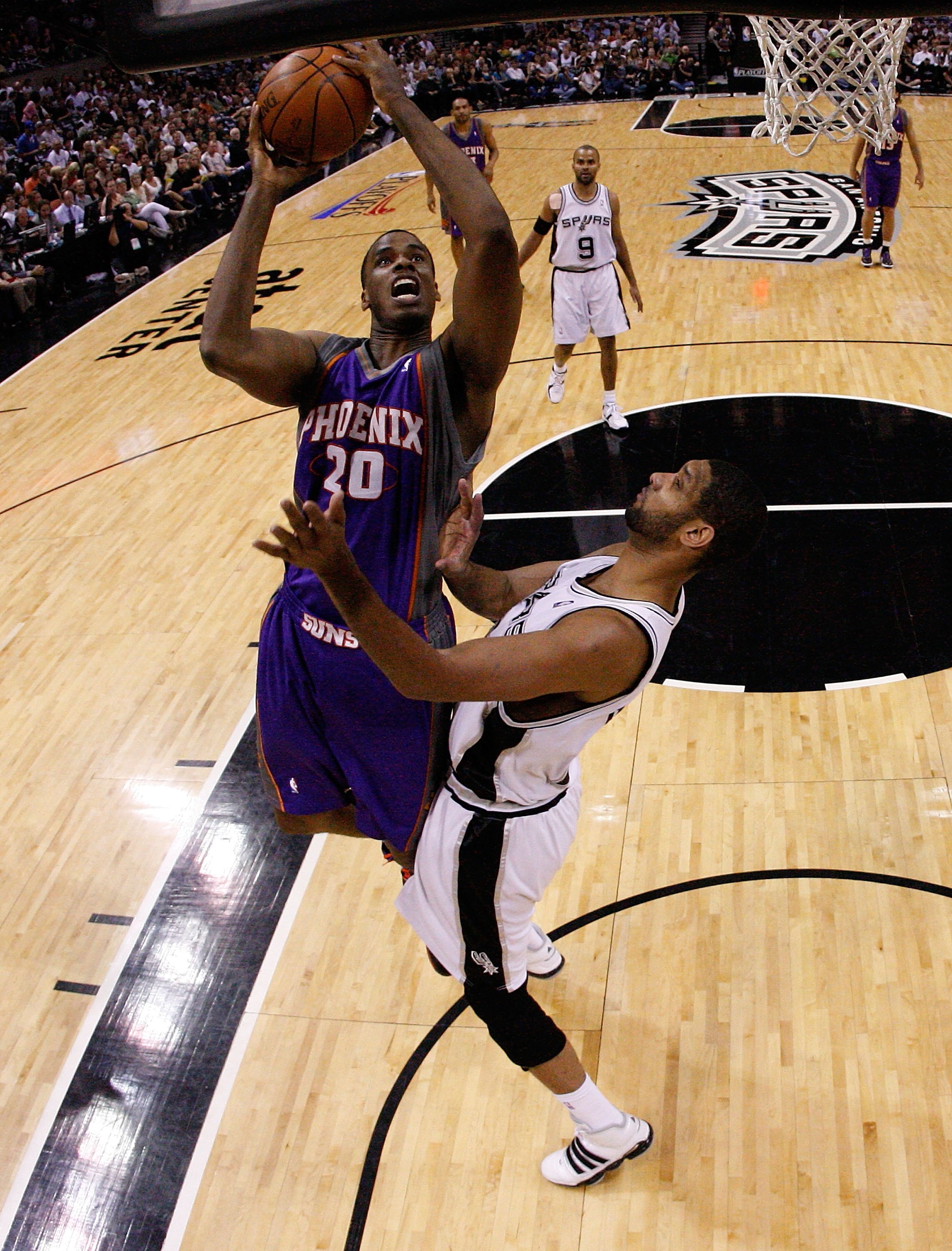 SAN ANTONIO - MAY 09:  Forward Dwayne Jones #20 of the Phoenix Suns takes a shot against Tim Duncan #21 of the San Antonio Spurs in Game Four of the Western Conference Semifinals during the 2010 NBA Playoffs at AT&T Center on May 9, 2010 in San Antonio, T
