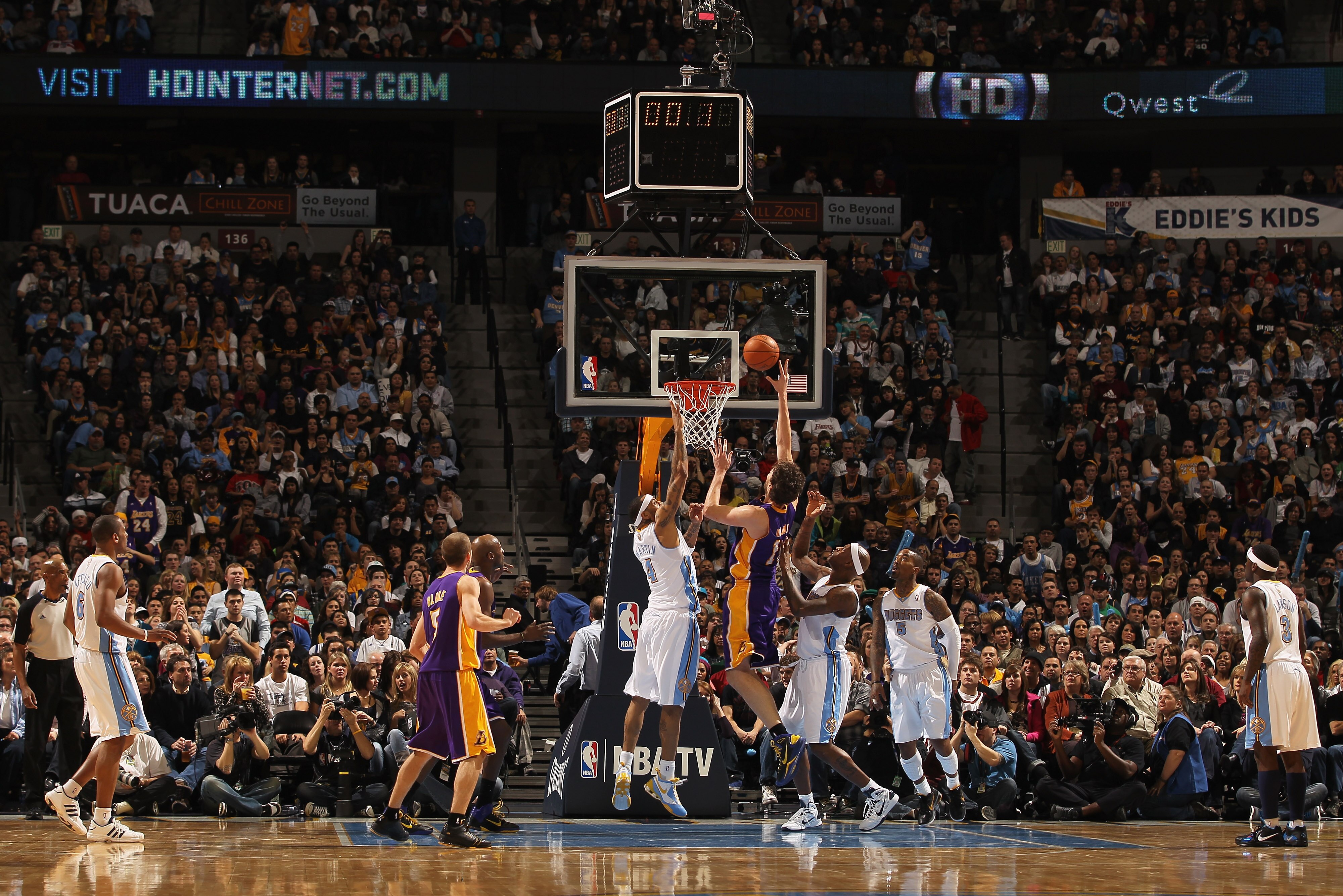 DENVER, CO - JANUARY 21:  Pau Gasol #16 of the Los Angeles Lakers puts up a shot between Kenyon Martin #4 and Al Harrington #7 of the Denver Nuggets at the Pepsi Center on January 21, 2011 in Denver, Colorado. The Lakers defeated the Nuggets 107-97. NOTE