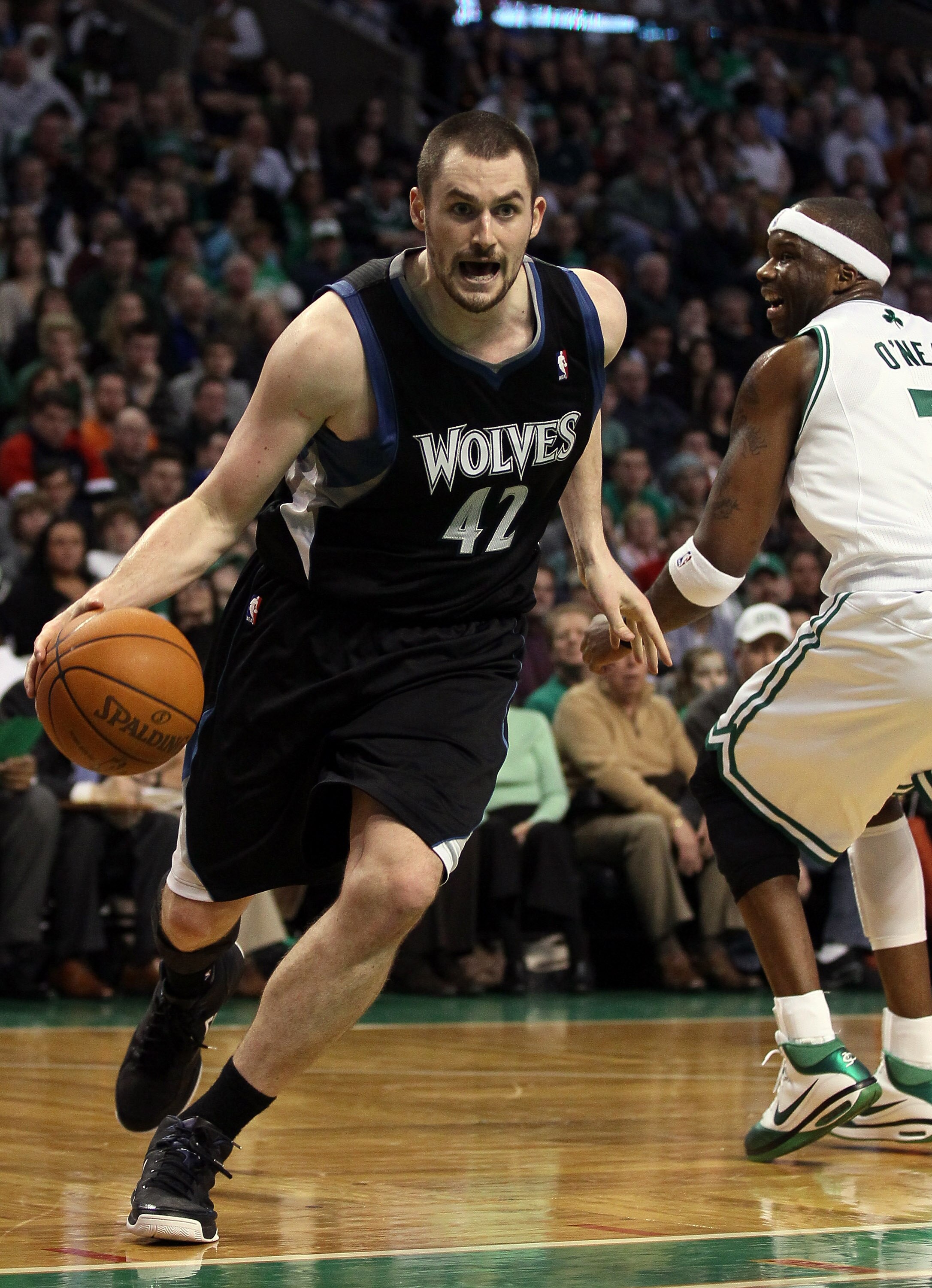 BOSTON, MA - JANUARY 03: Kevin Love #42 of the Minnesota Timberwolves drives around Jermaine O'Neal #7 of the Boston Celtics on January 3, 2011 at the TD Garden in Boston, Massachusetts. The Celtics defeated the Timberwolves 96-93. NOTE TO USER: User exp BOSTON, MA - JANUARY 03: Kevin Love #42 of the Minnesota Timberwolves drives around Jermaine O'Neal #7 of the Boston Celtics on January 3, 2011 at the TD Garden in Boston, Massachusetts. The Celtics defeated the Timberwolves 96-93. NOTE TO USER: User exp