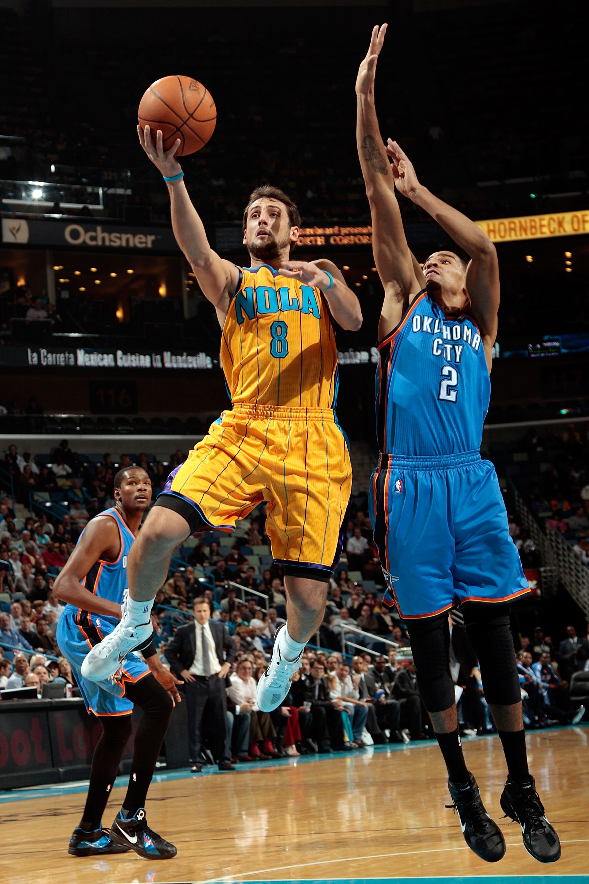 NEW ORLEANS, LA - DECEMBER 10:  Marco Belinelli #8 of the New Orleans Hornets makes a shot over Thabo Sefolosha #2 of the Oklahoma City Thunder at New Orleans Arena on December 10, 2010 in New Orleans, Louisiana.    NOTE TO USER: User expressly acknowledg