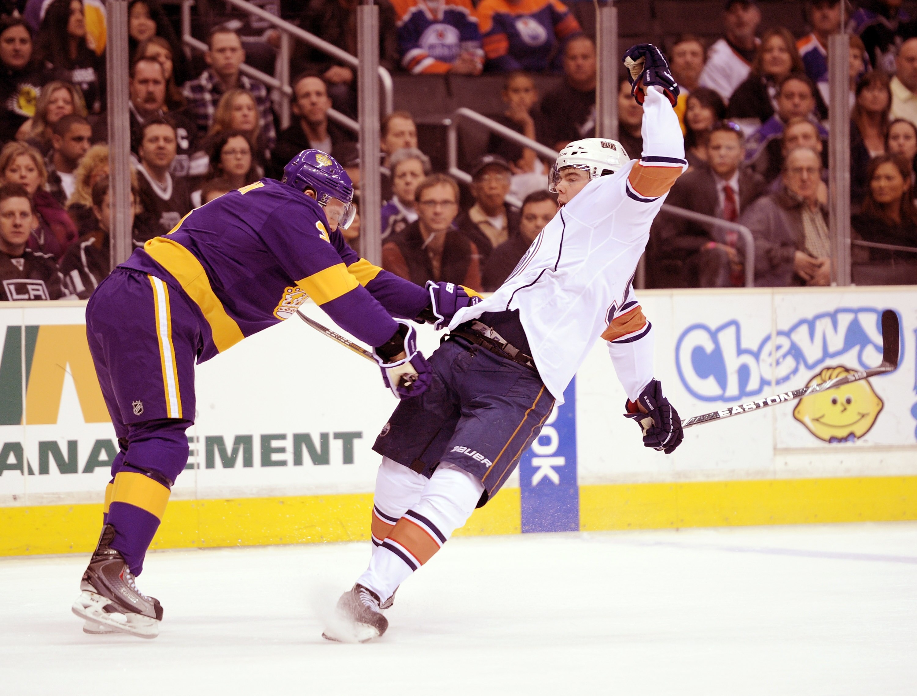 LOS ANGELES, CA - JANUARY 15:  Magnus Paajarvi #91 of the Edmonton Oilers is knocked off balance by Jack Johnson #3 of the Los Angeles Kings during the first period at the Staples Center on January 15, 2011 in Los Angeles, California.  (Photo by Harry How