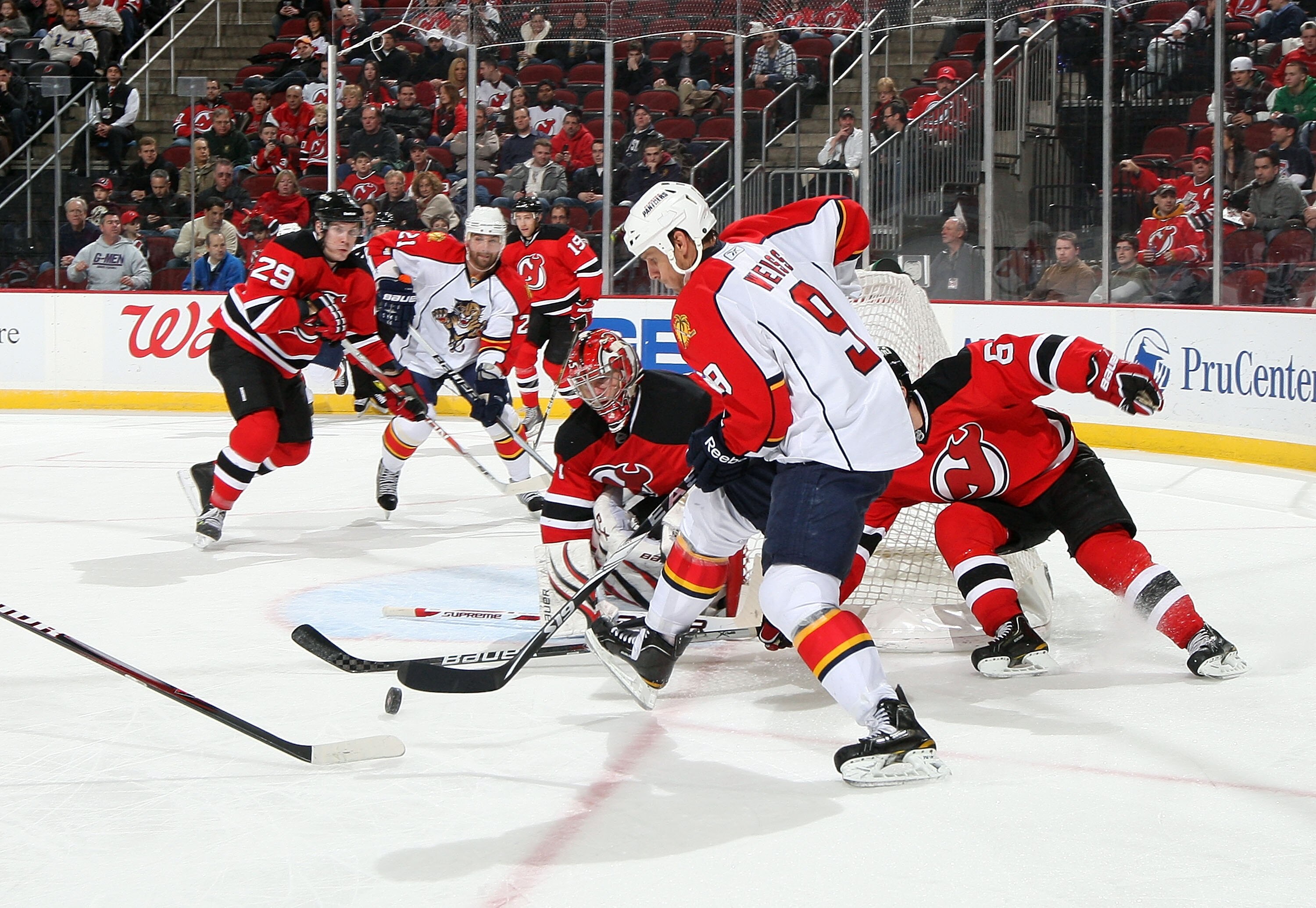 NEWARK, NJ - FEBRUARY 04:  Stephen Weiss #9 of the Florida Panthers attempts a shot against Johan Hedberg #1 of the New Jersey Devils at the Prudential Center on February 4, 2011 in Newark, New Jersey. Florida defeated the Devils 4-3 in overtime.  (Photo