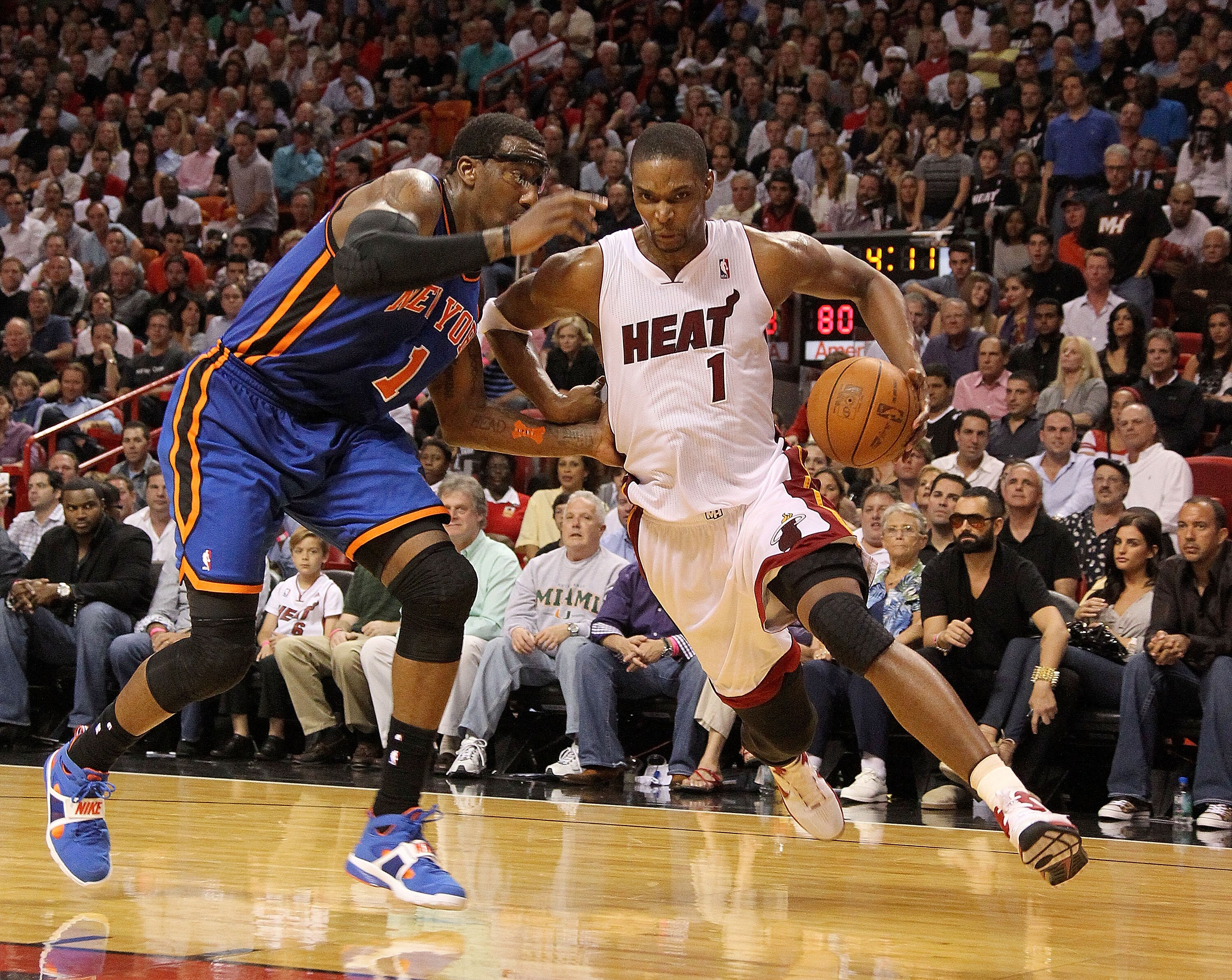 MIAMI, FL - FEBRUARY 27: Chris Bosh #1 of the Miami Heat drives past Amar'e Stoudemire #1 of the New York Knicks during a game at American Airlines Arena on February 27, 2011 in Miami, Florida. NOTE TO USER: User expressly acknowledges and agrees that, by