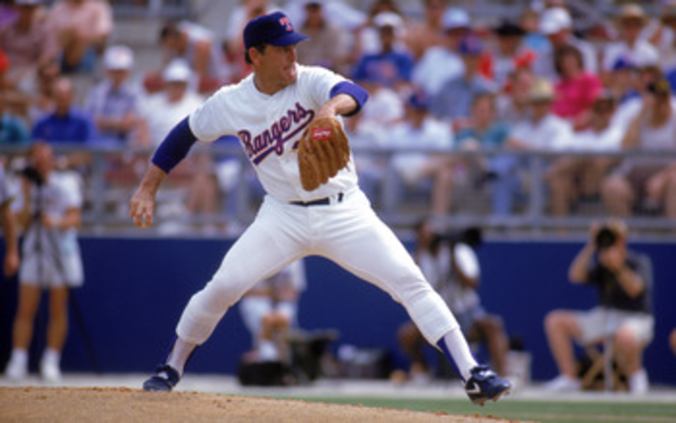 ARLINGTON, TX - 1990s:  Nolan Ryan #34 of the Texas Rangers pitches during a circa 1990s game at Arlington Stadium in Arlington, Texas. Ryan pitched for the Rangers from 1989-93.  (Photo by Jonathan Daniel/Getty Images)