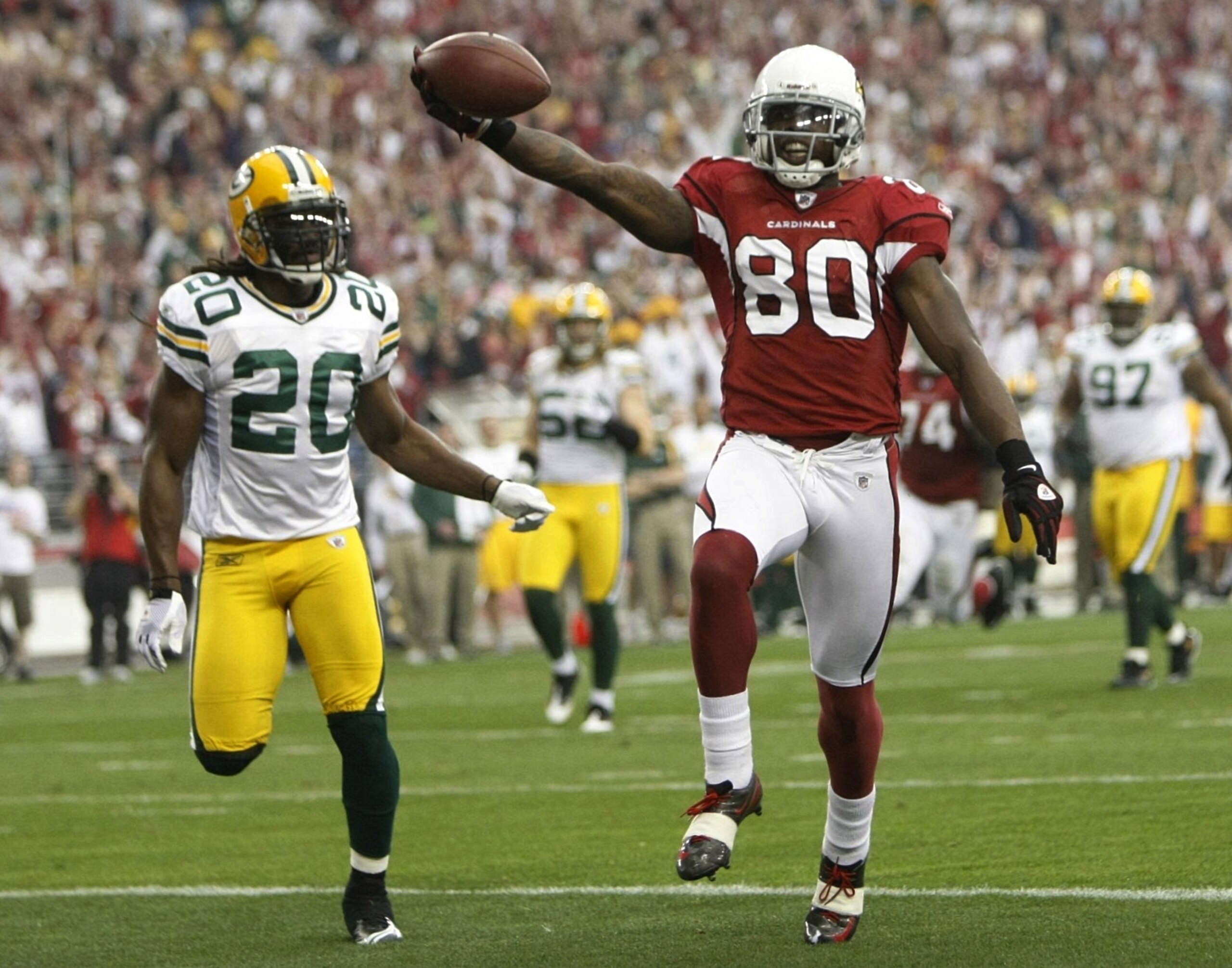 GLENDALE, AZ - JANUARY 10:  Wide receiver Early Doucet #80 of the Arizona Cardinals scores a touchdown against the Green Bay Packers during the first quarter of the 2010 NFC wild-card playoff game at University of Phoenix Stadium on January 10, 2010 in Gl