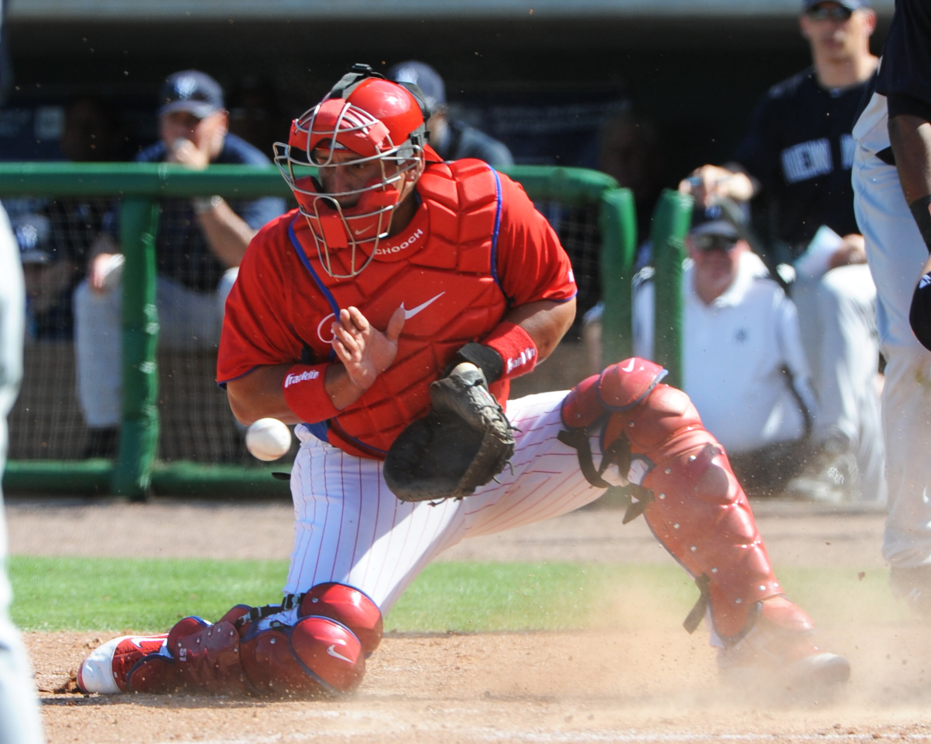 CLEARWATER, FL - FEBRUARY 27:  Catcher Carols Ruiz #51 of the Philadelphia Phillies blocks a throw to the plate against the New York Yankees February 27, 2011 at Bright House Field in Clearwater, Florida.  (Photo by Al Messerschmidt/Getty Images)