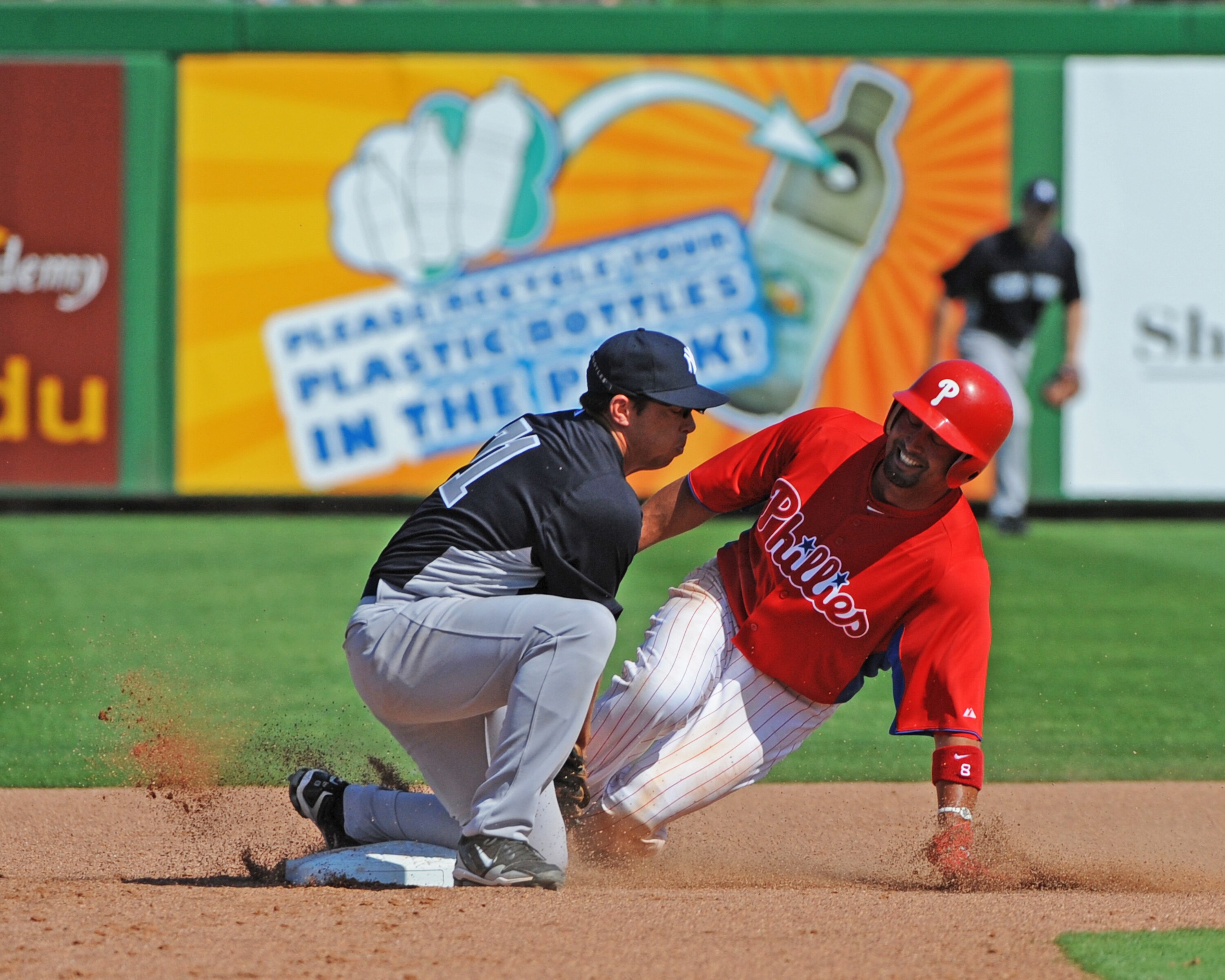 CLEARWATER, FL - FEBRUARY 27:  Outfielder Shane Victorino #8 of the Philadelphia Phillies steals second base against the New York Yankees February 27, 2011 at Bright House Field in Clearwater, Florida.  (Photo by Al Messerschmidt/Getty Images)