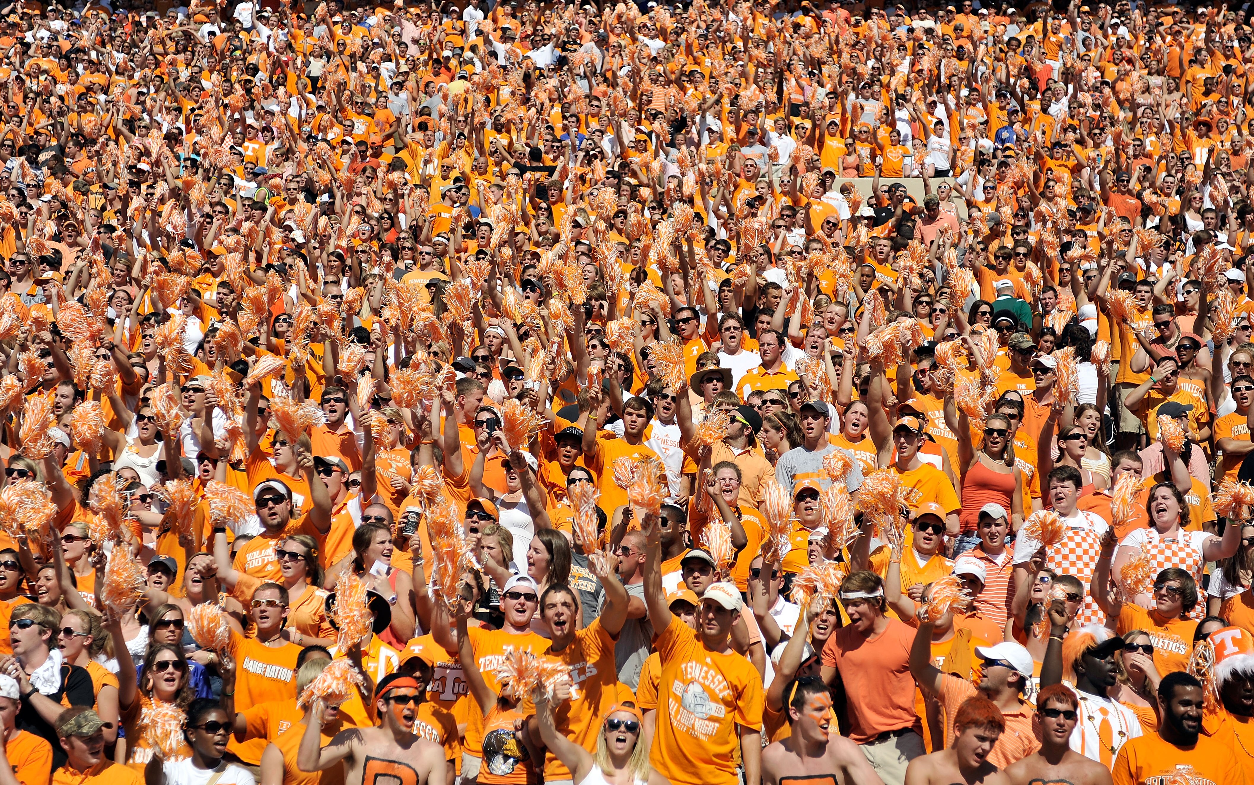KNOXVILLE, TN - SEPTEMBER 18:  Orange-clad Tennessee Volunteers fans sing along with 'Rocky Top' during a game against the Florida Gators at Neyland Stadium on September 18, 2010 in Knoxville, Tennessee. Florida won 31-17.  (Photo by Grant Halverson/Getty